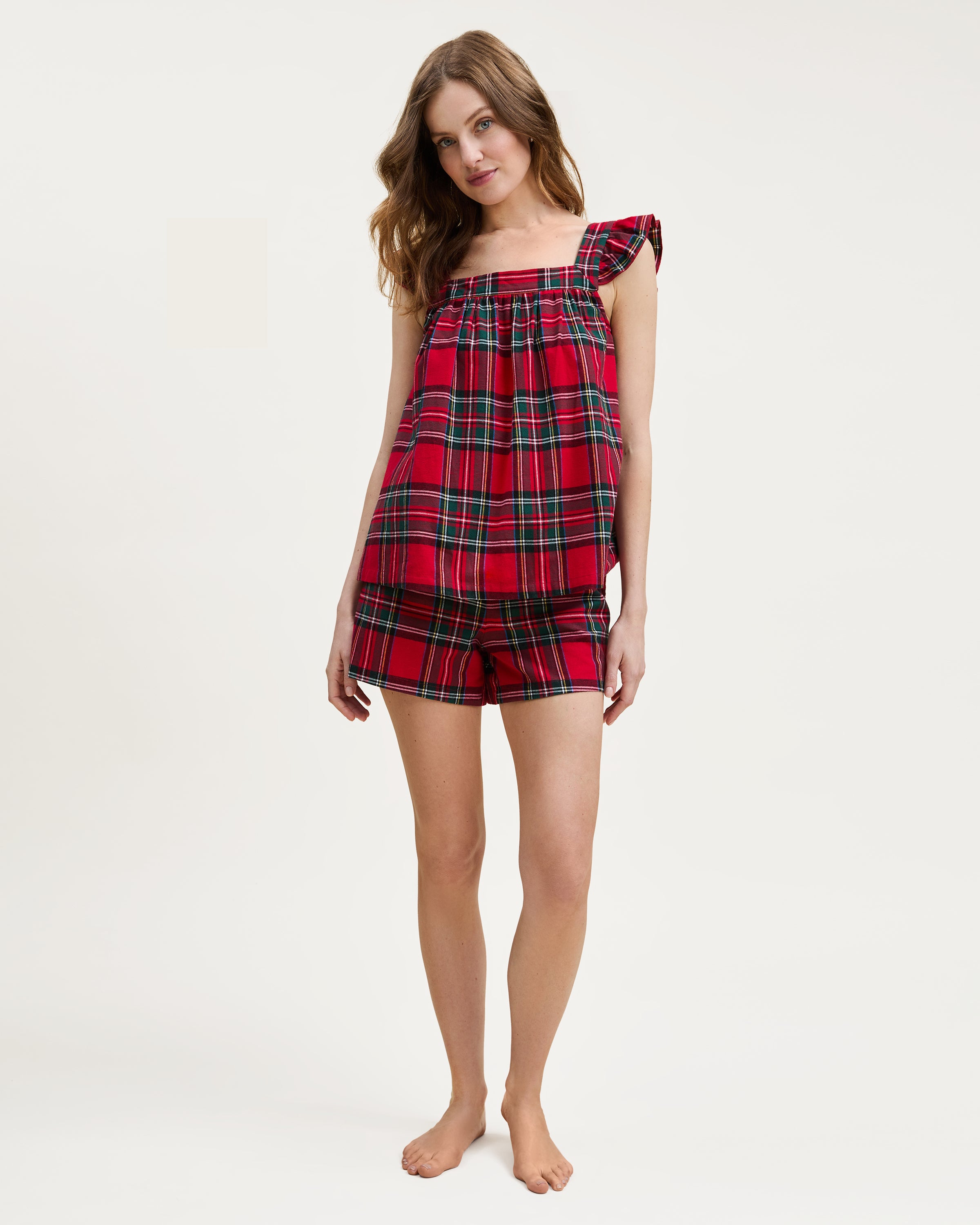 The Women's Brushed Twill Clara Short Set in Imperial Tartan features a red, green, white, and black plaid pattern with a sleeveless ruffled top and elastic-waist shorts, displayed flat on a white background.