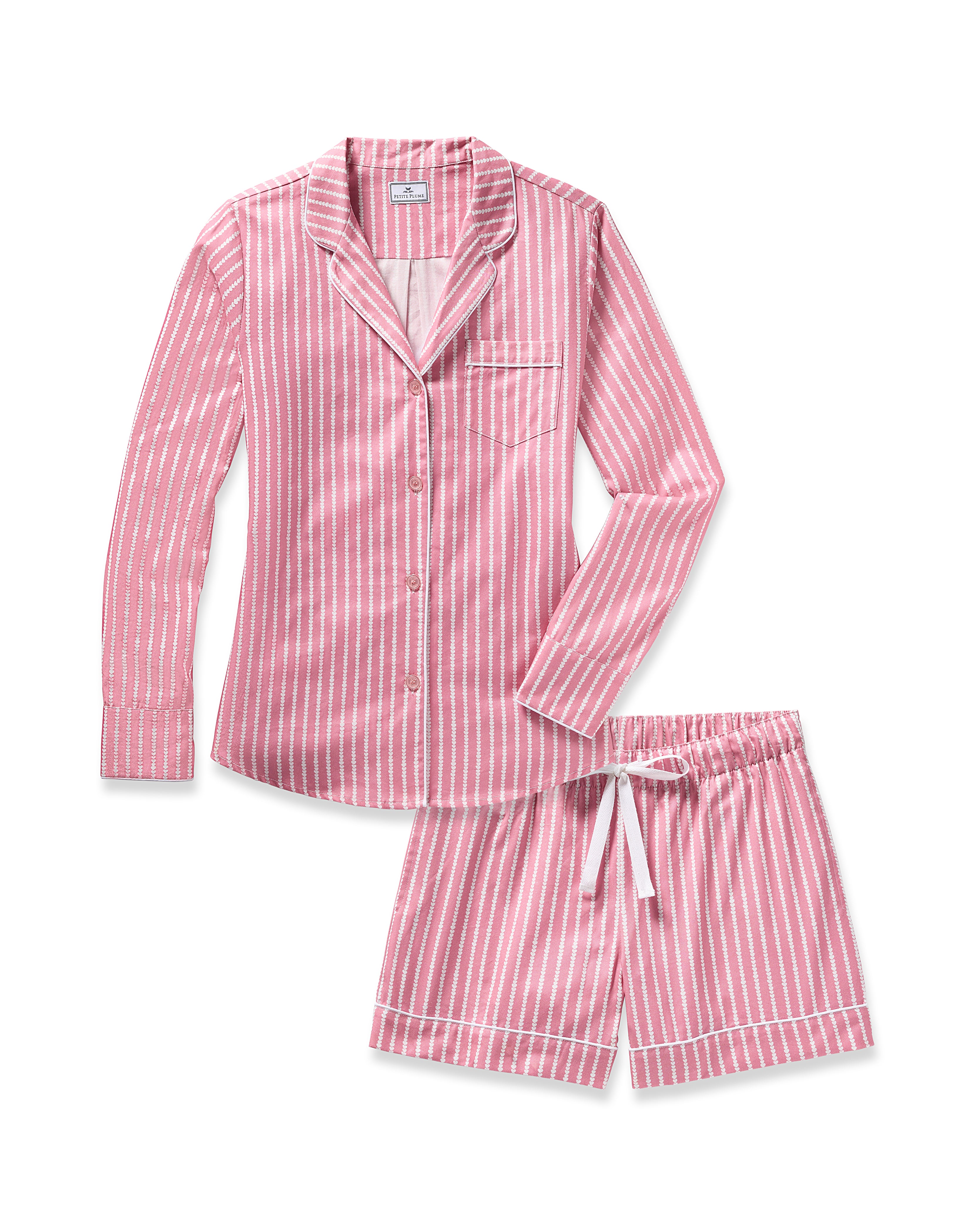 Introducing the Womens Twill Long Sleeve Short Set in Love Lines by Petite Plume, a luxurious pink and white striped pajama crafted from top-quality cotton. It features a button-up shirt with a collar and chest pocket, paired with cozy drawstring shorts.