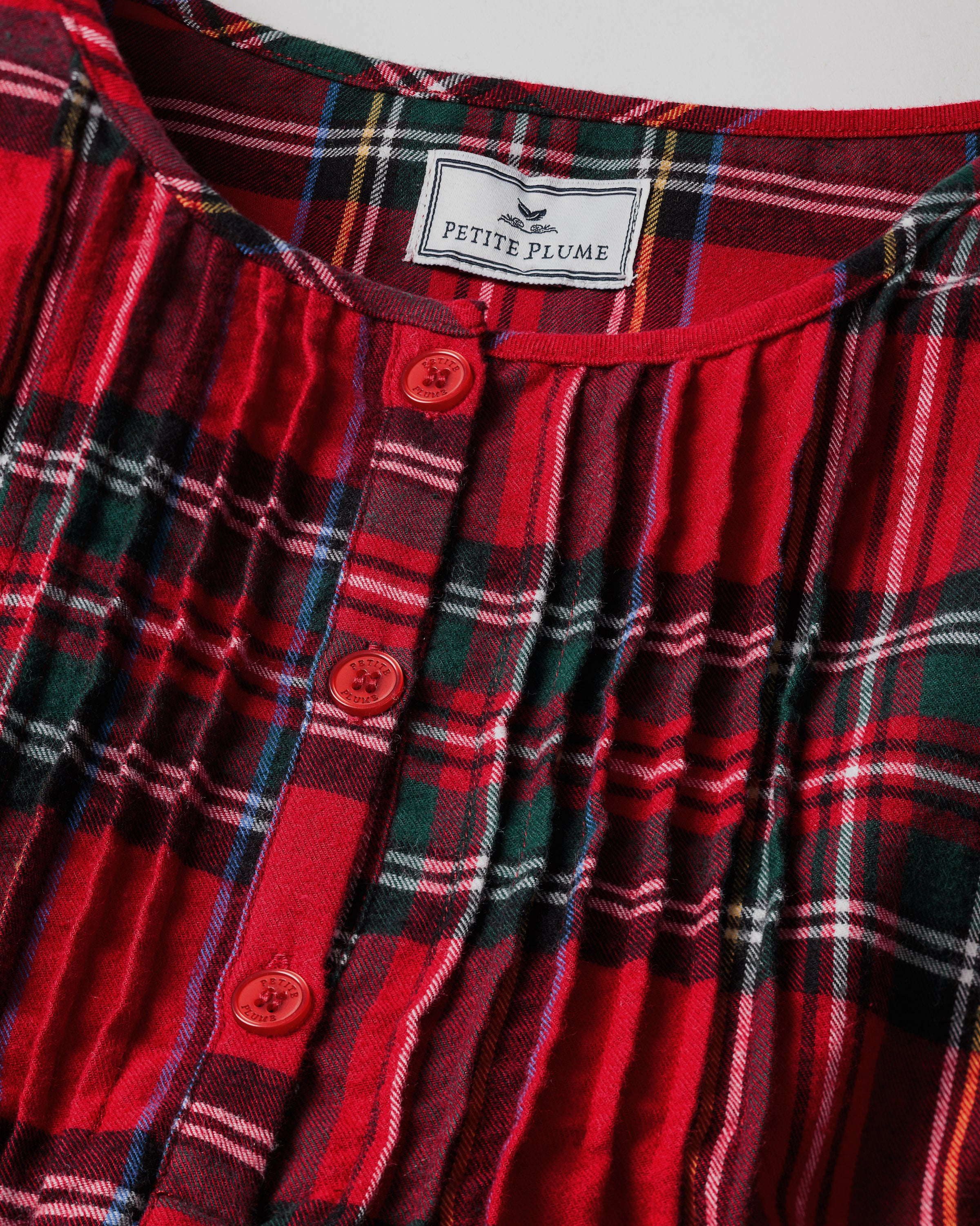The Women's Brushed Twill Beatrice Nightgown in Imperial Tartan features long sleeves, a knee-length cut, a red, green, and black plaid design, chest buttons, and a round neckline.