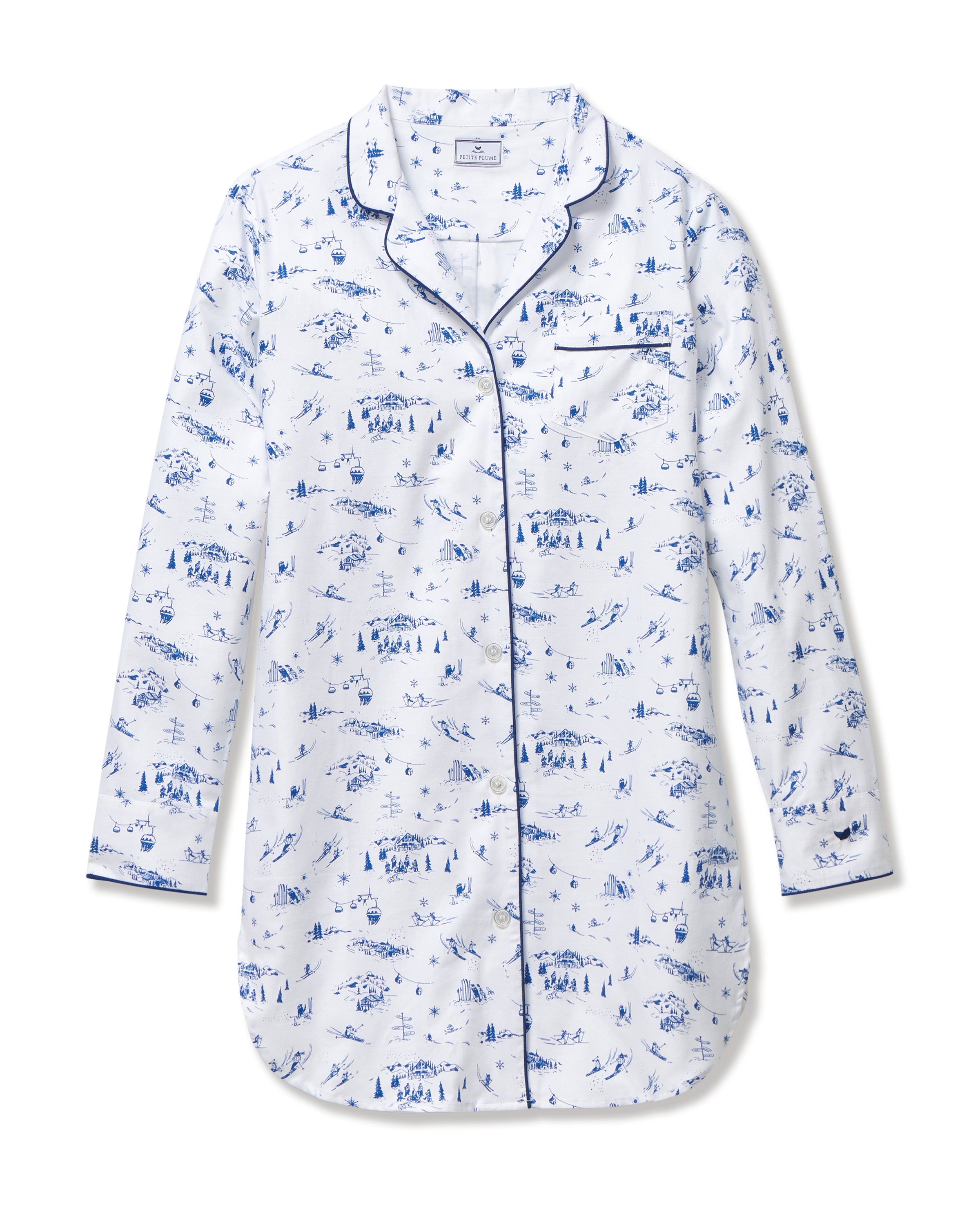 The Women's Twill Nightshirt in Chalet Toile features long sleeves, a white button-up design, a blue scenic print, and dark blue piping on the collar, cuffs, and pocket.