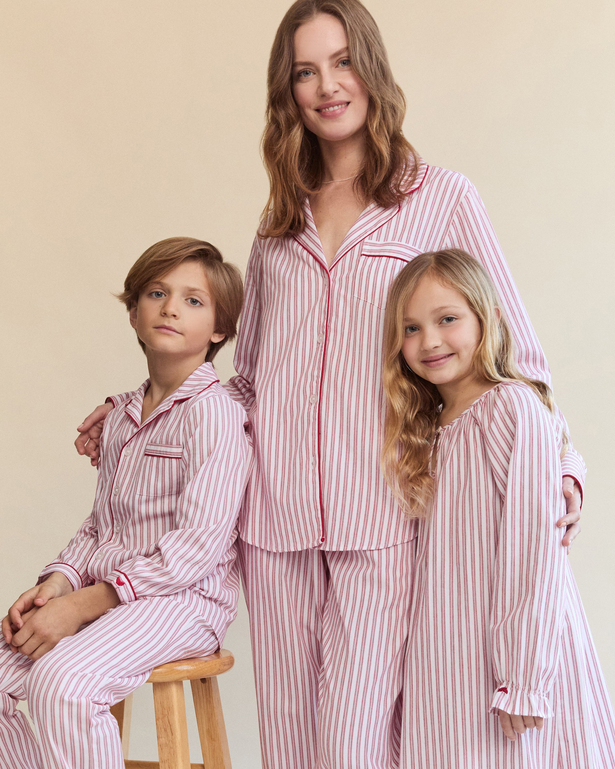 The Womens Twill Pajama Set in Antique Red Ticking by Petite Plume features a white shirt with red vertical stripes, front pocket, and button closure. Made from soft, lightweight fabric, the classic pattern offers comfort for sleepwear or casual wear.