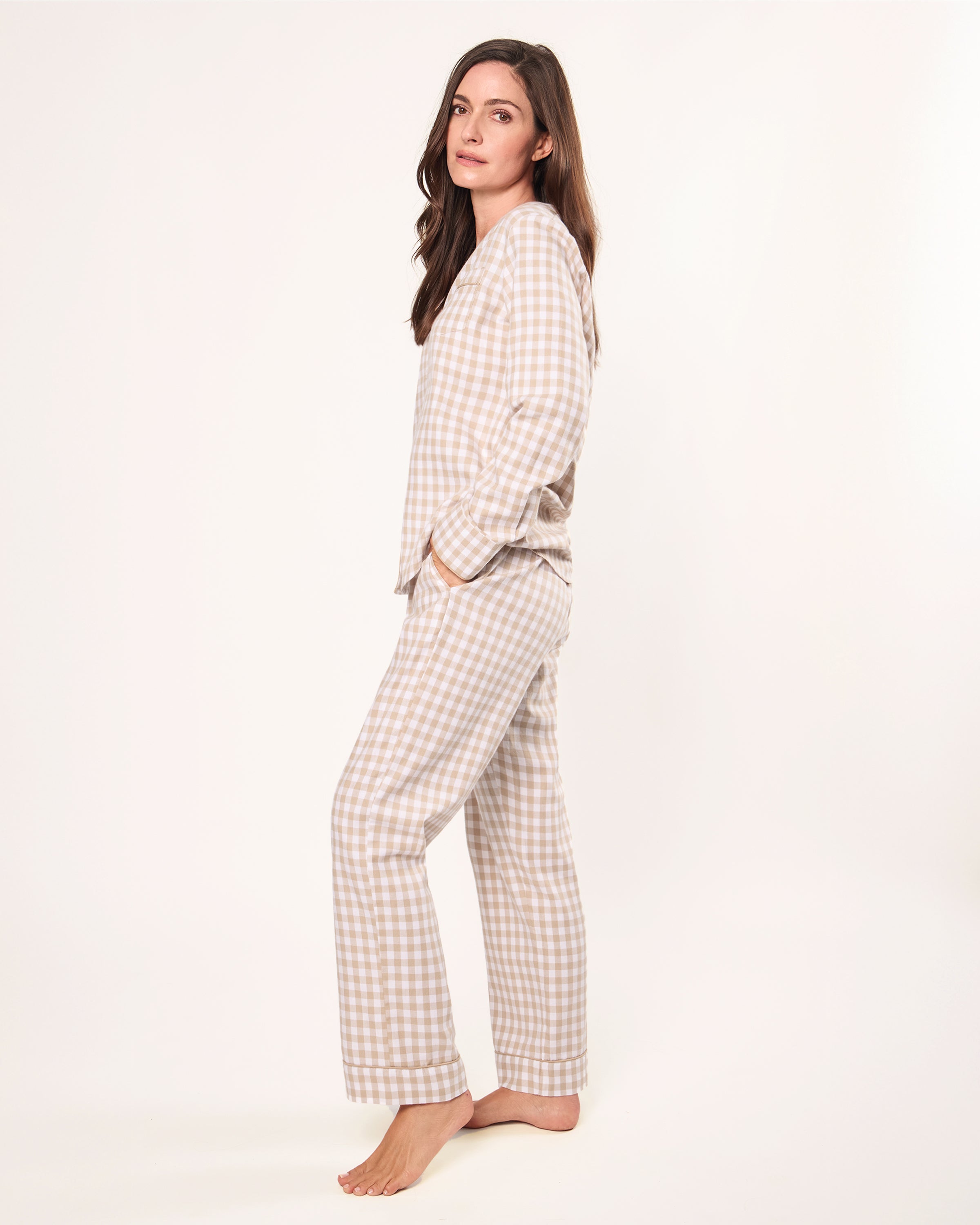 The Women's Twill Pajama Set in Camel Gingham features a beige and white check long-sleeve, button-up top with chest pocket and matching drawstring pants, displayed neatly on a white background.