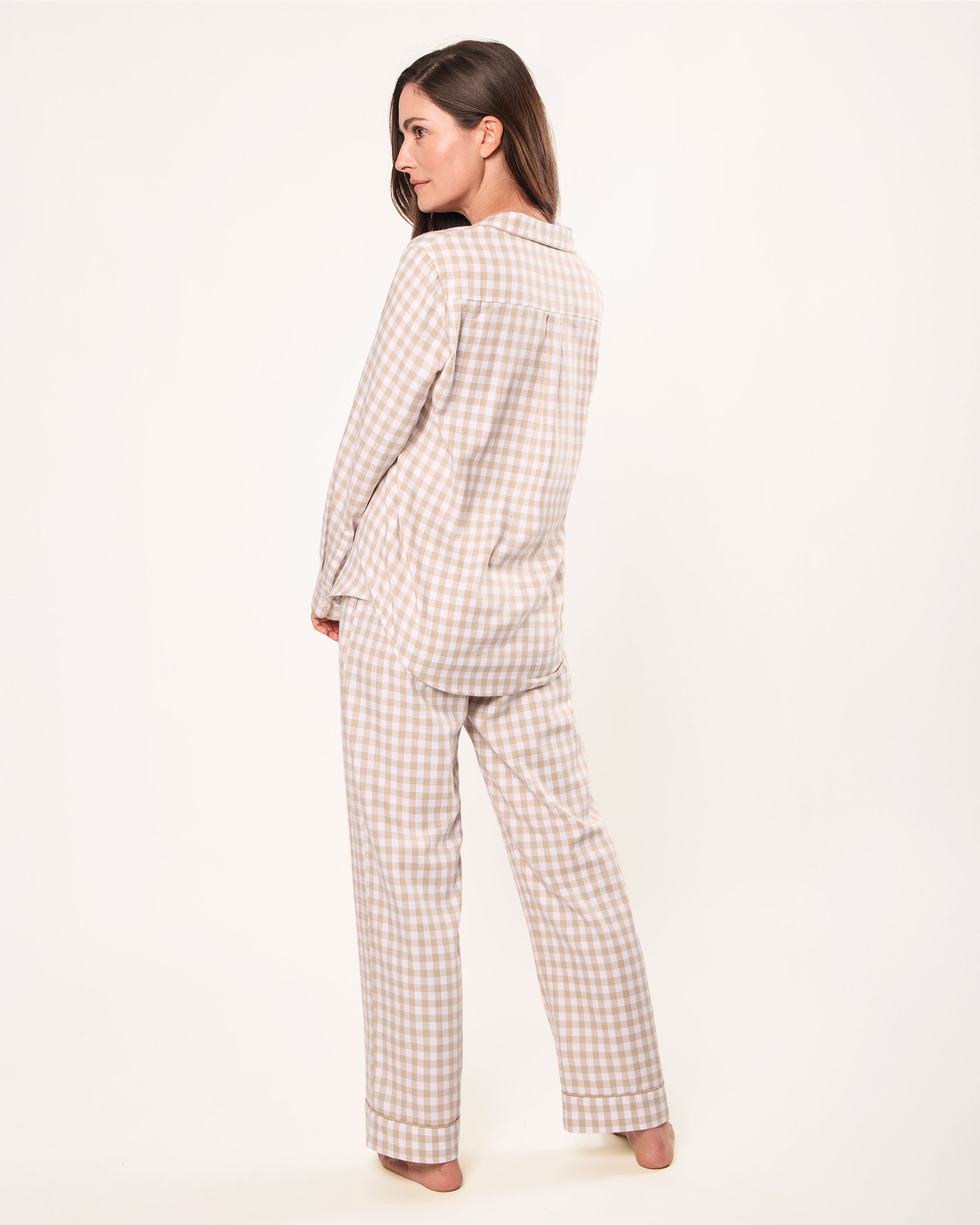 The Women's Twill Pajama Set in Camel Gingham features a beige and white check long-sleeve, button-up top with chest pocket and matching drawstring pants, displayed neatly on a white background.