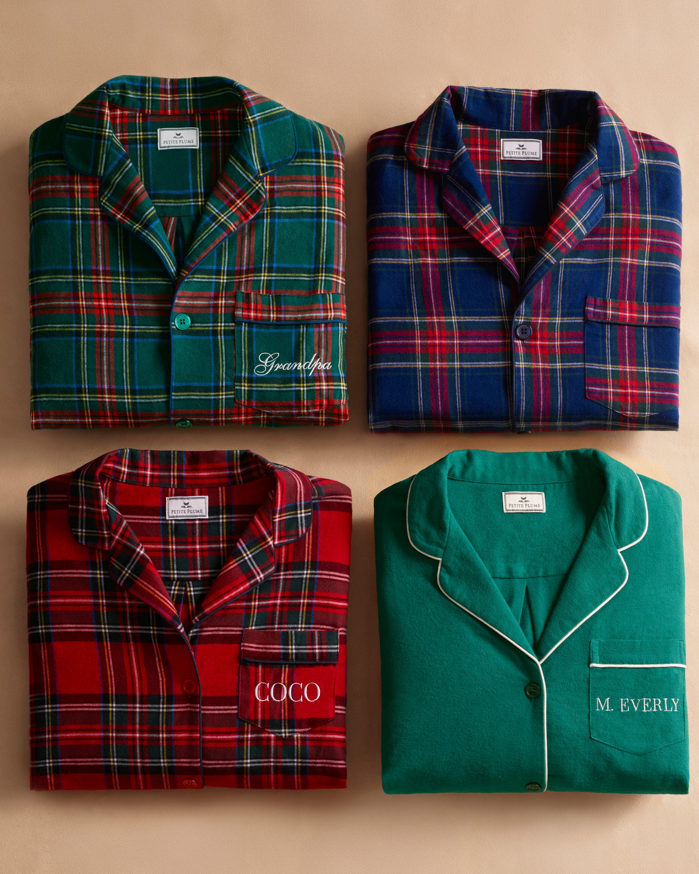 Close-up of Windsor Tartan fabric with red, green, and white stripes on navy by Petite Plume. The soft, brushed cotton texture resembles a classic pajama set with a button and lapel for added coziness.