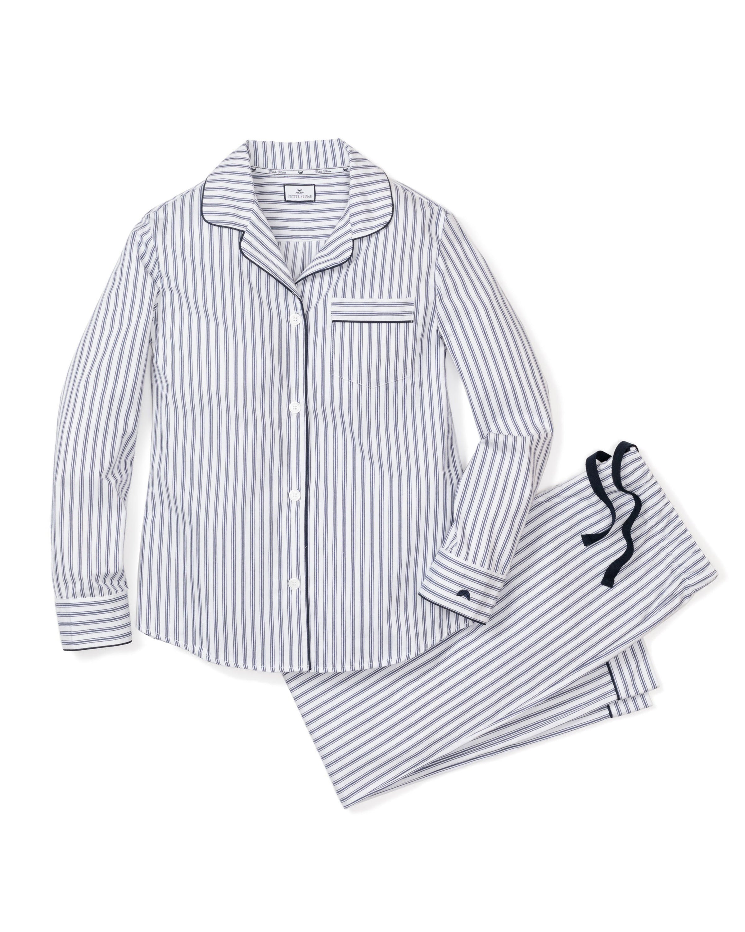 Womens Twill Pajama Set in Navy French Ticking by Petite Plume, shown on a white background, features a cotton twill long-sleeve button-up top with front pocket and drawstring pants. The stripes are inspired by a French ticking design with alternating light and dark gray lines.