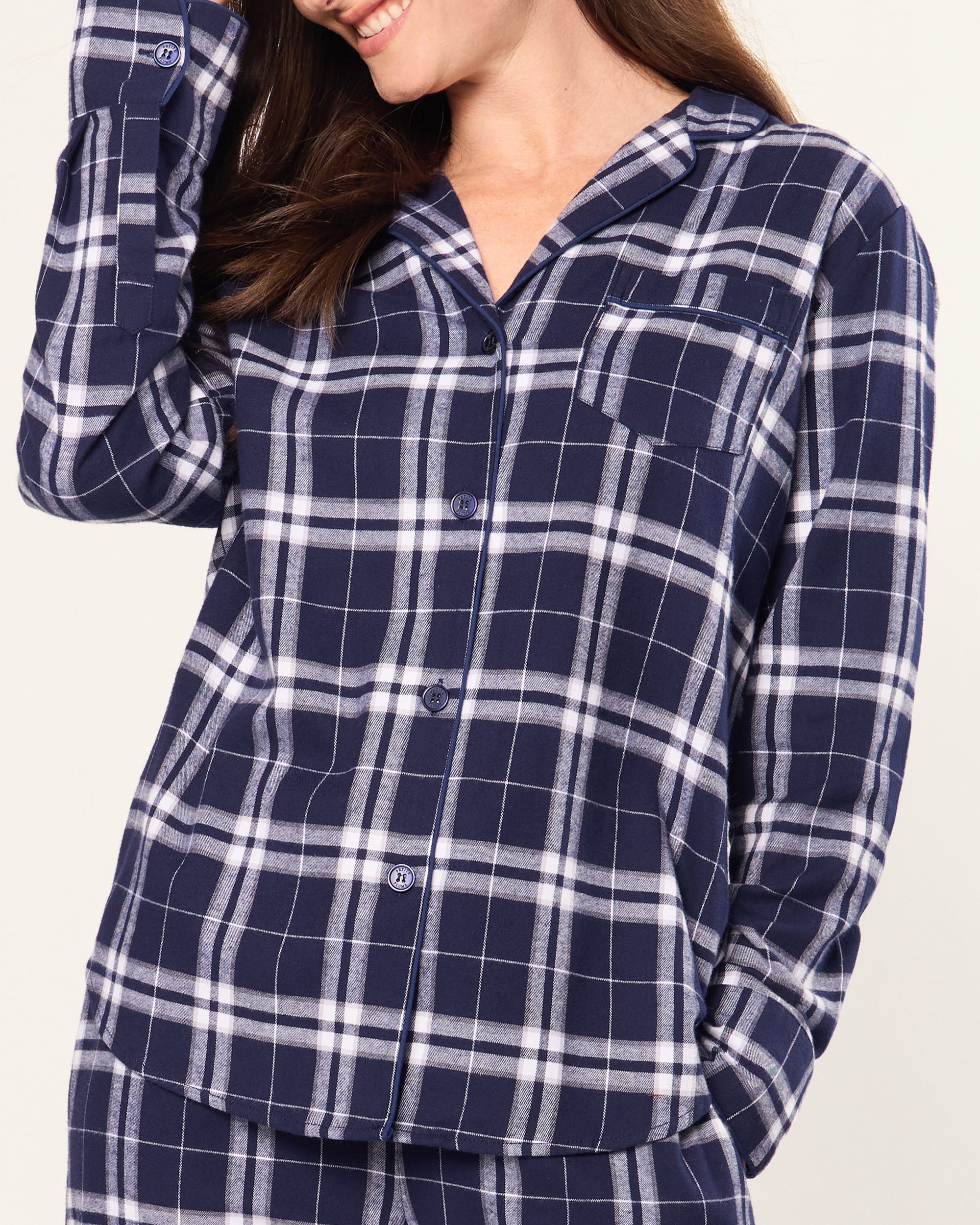 The Women's Brushed Twill Pajama Set in Oxford Tartan features a blue and white plaid long-sleeve button-up shirt with a chest pocket and matching drawstring pants, all displayed on a white background.