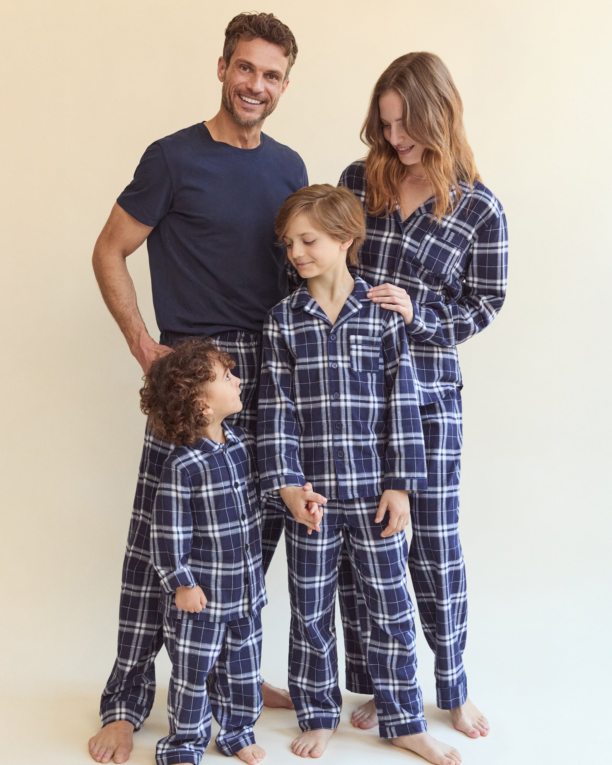 The Women's Brushed Twill Pajama Set in Oxford Tartan features a blue and white plaid long-sleeve button-up shirt with a chest pocket and matching drawstring pants, all displayed on a white background.