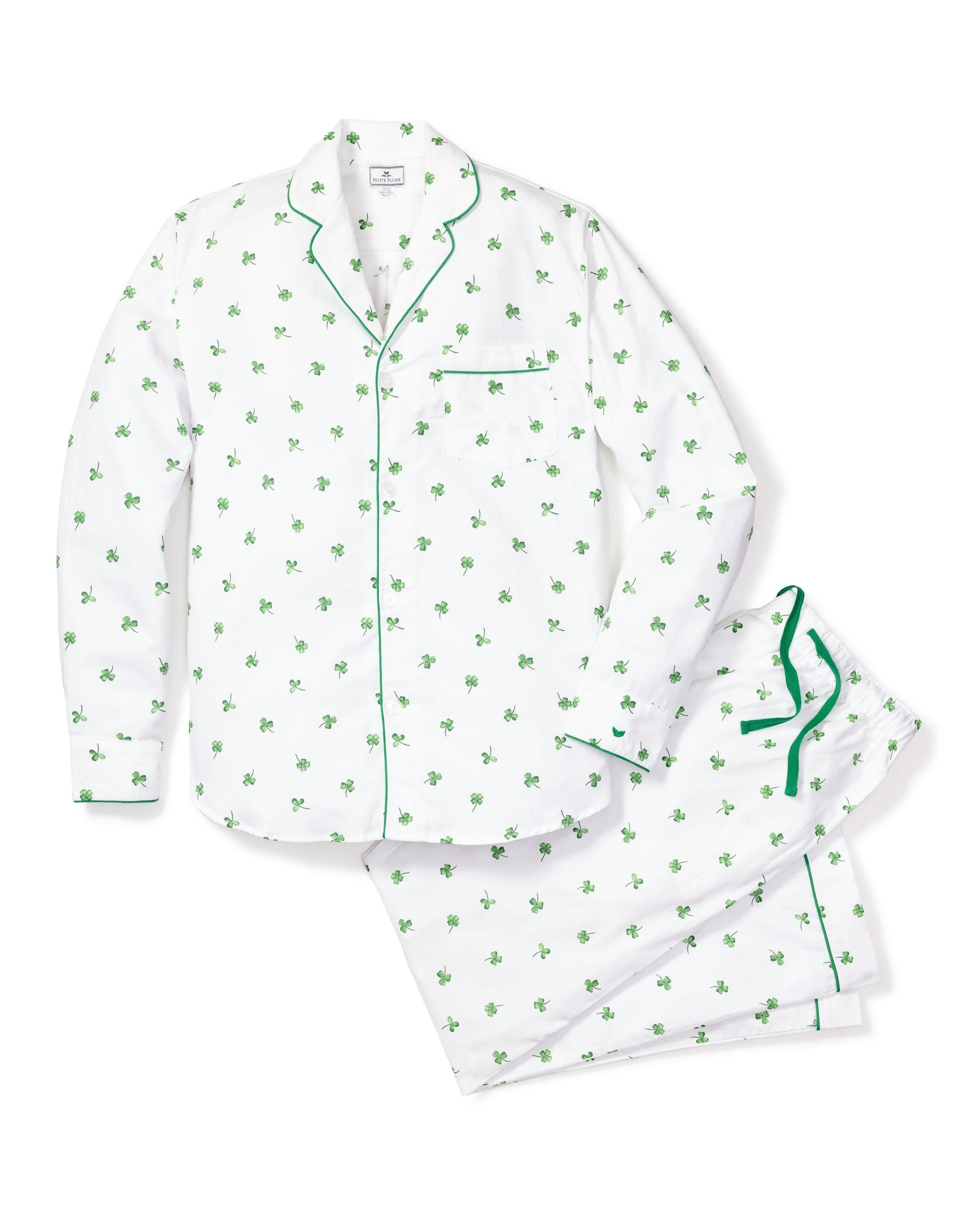 A women's pajama set with a white twill fabric featuring a green shamrock print, including a long-sleeved shirt and pants with a drawstring.