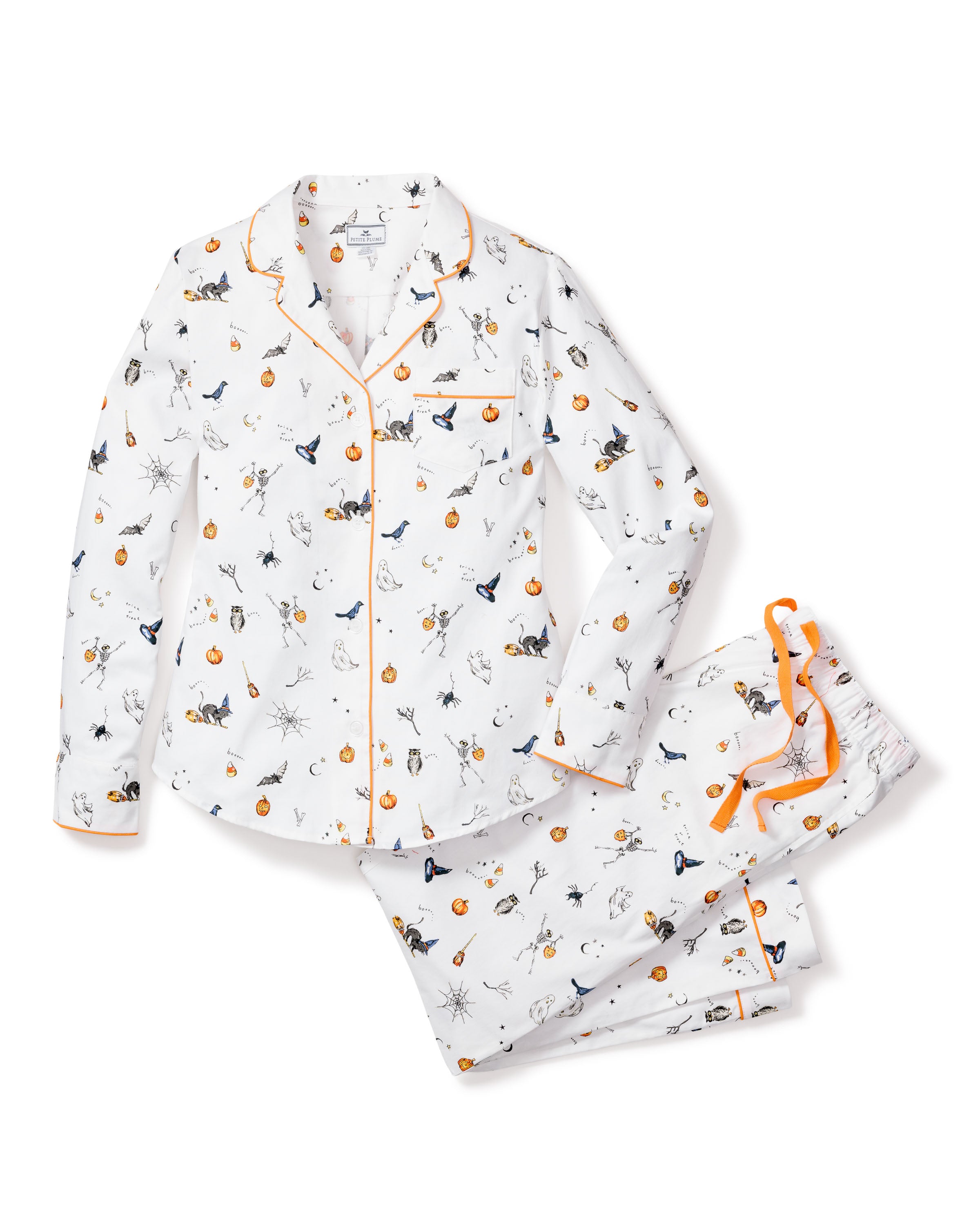 Cozy up in the Womens Twill Pajama Set in Trick or Treat by Petite Plume, featuring a playful print with pumpkins, ghosts, bats, and spiders. The white set includes orange piping and buttons; the top has a collar, while the pants have an elastic waist with an orange tie.