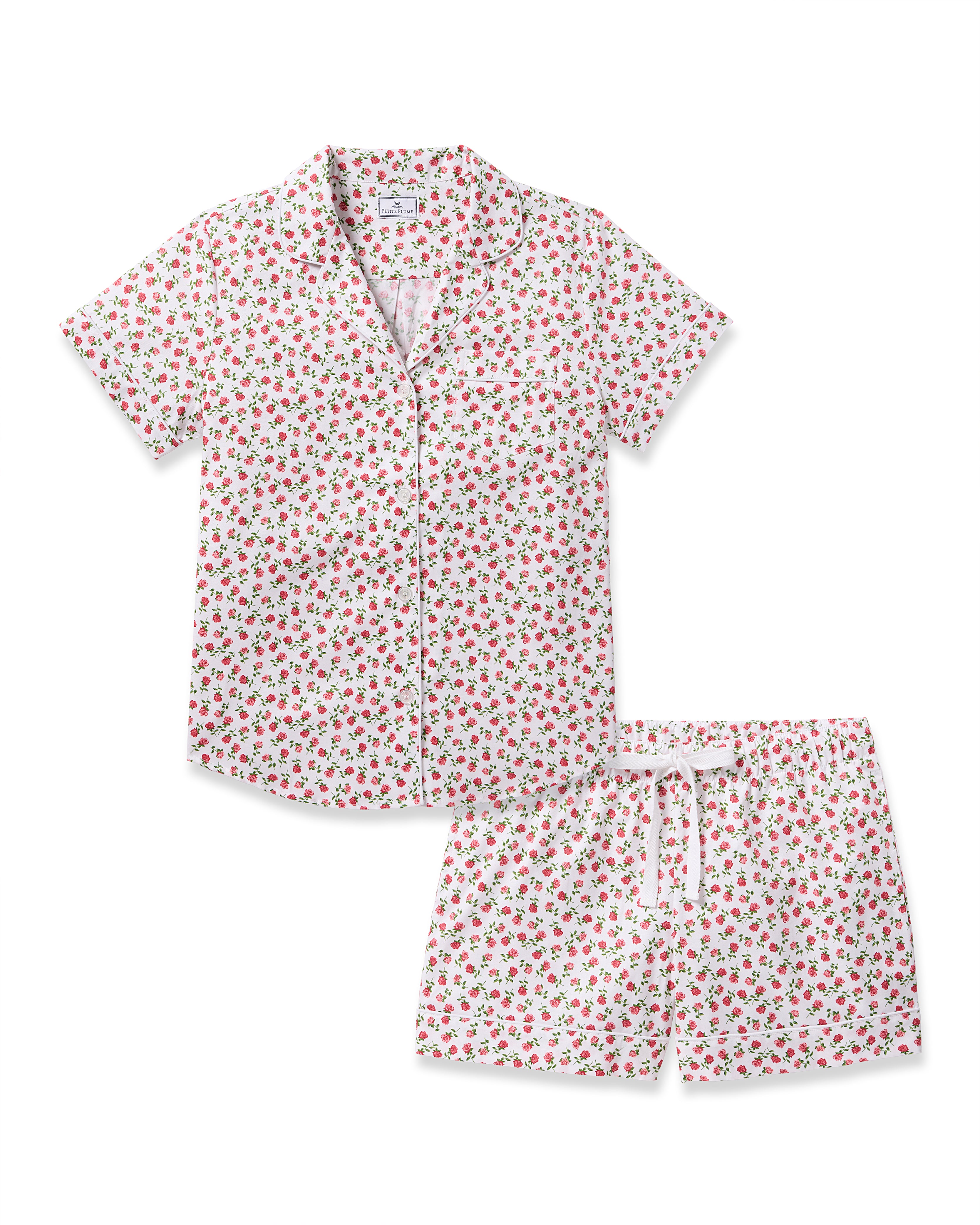 The Womens Twill Short Sleeve Short Set in Petite Petals by Petite Plume offers a luxurious pajama set featuring a white base with red florals, consisting of a short-sleeved button-up shirt with collar and matching shorts with an elastic waistband and drawstring for exquisite comfort.