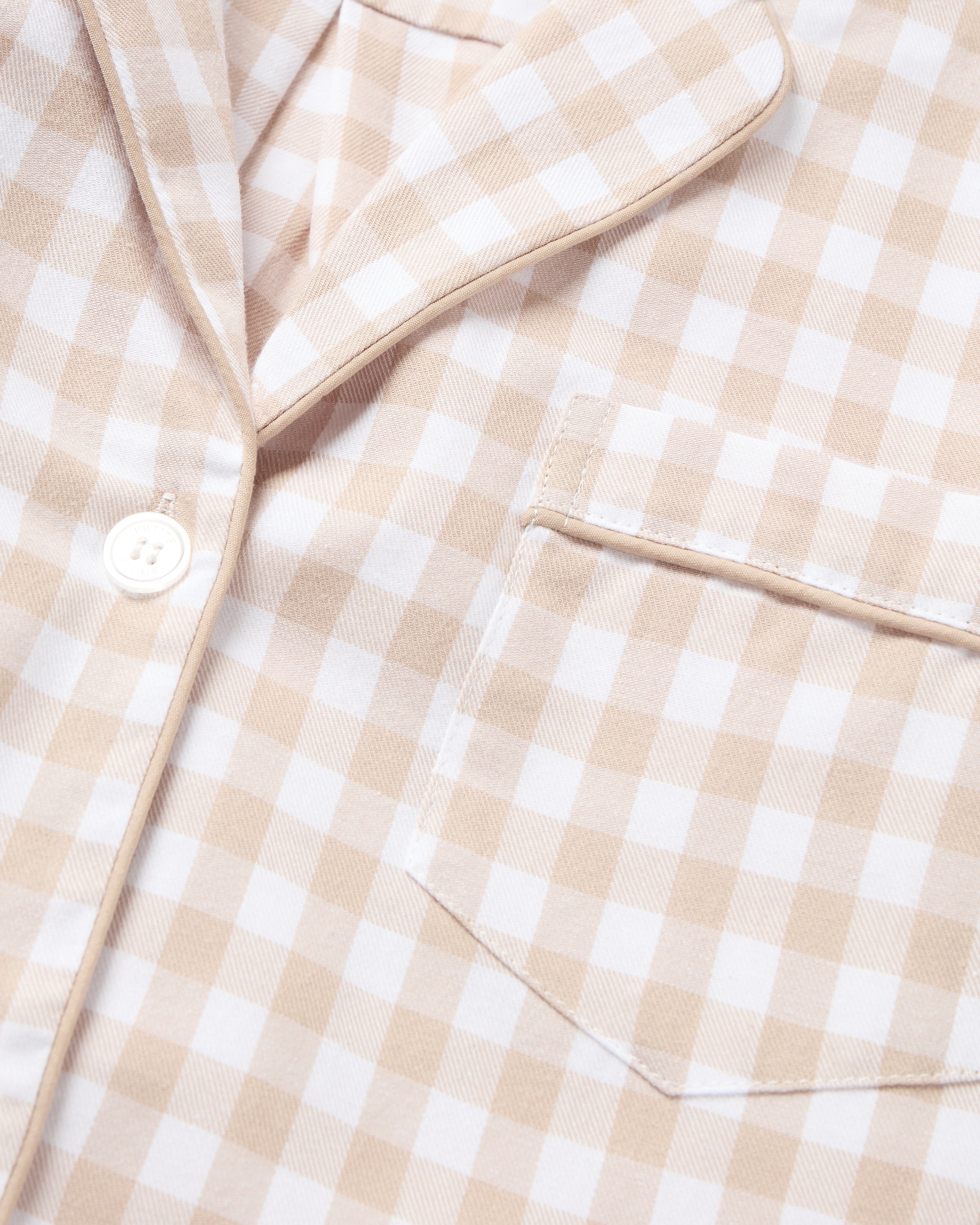 The Women's Twill Short Sleeve Short Set in Camel Gingham features a button-up shirt and matching drawstring shorts with a beige and white gingham pattern.
