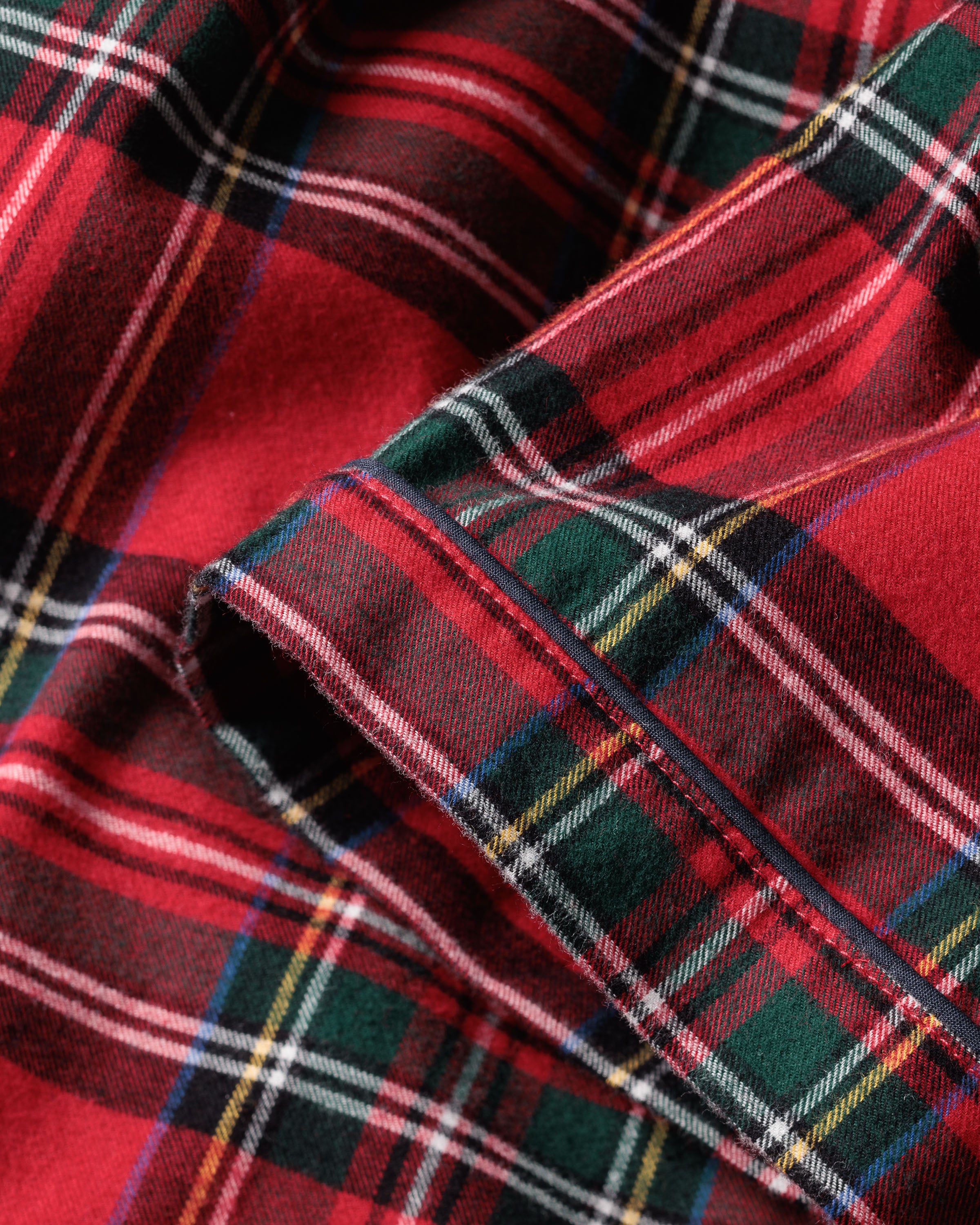 Close-up of the Womens Brushed Cotton Short Sleeve Short Set in Imperial Tartan by Petite Plume shows its detailed texture and vibrant red, green, and black plaid pattern.