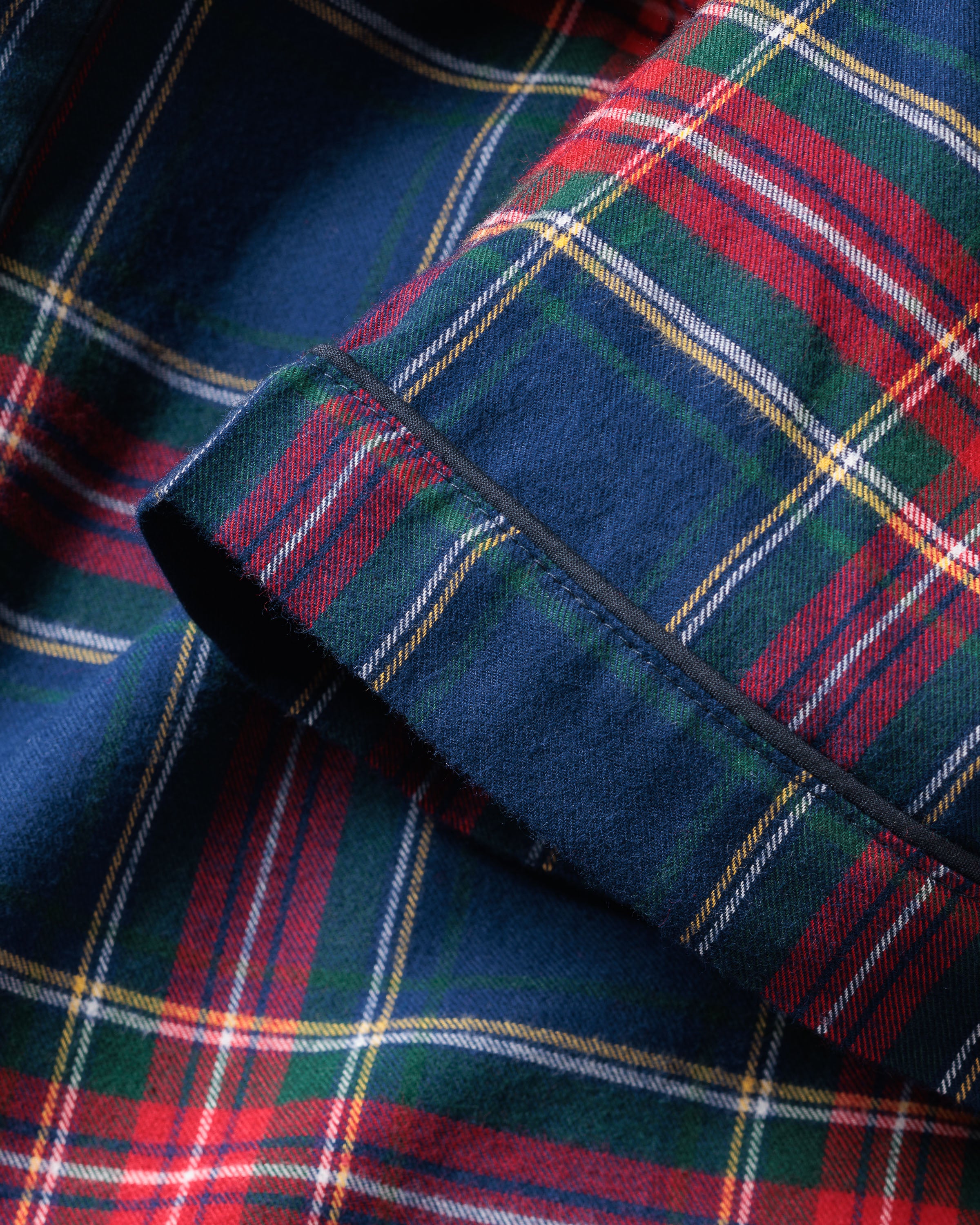 Close-up of Petite Plumes Womens Brushed Cotton Short Sleeve Short Set in Windsor Tartan, featuring a vibrant plaid pattern with intersecting red, green, blue, and yellow lines. The detailed texture highlights the soft material ideal for luxury sleepwear.