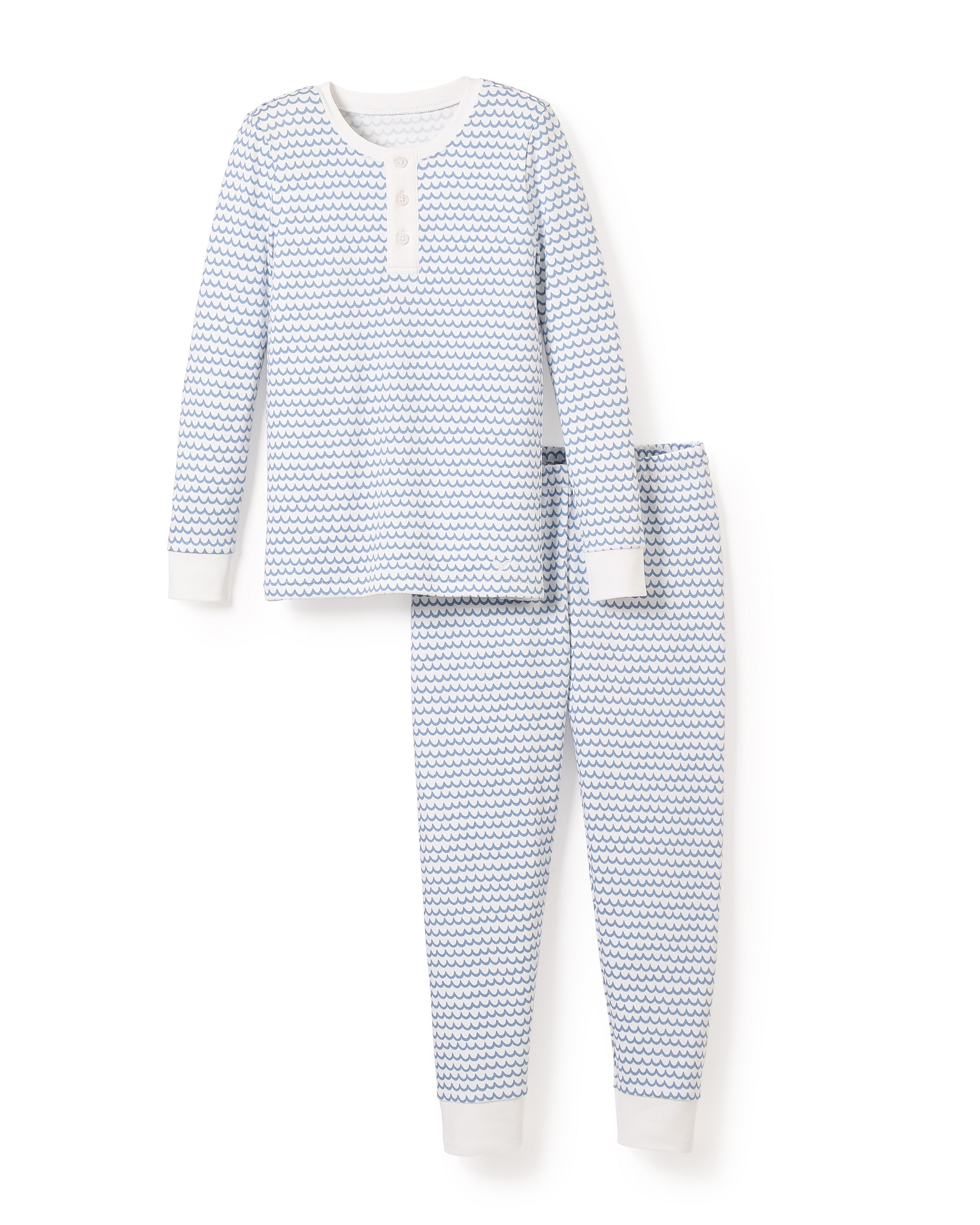 The Kids Pima Snug Fit Pajama Set in La Mer by Petite Plume features a blue and white wave pattern, with a long-sleeve henley top and matching pants. Both pieces have white cuffs at the wrists and ankles for comfort.