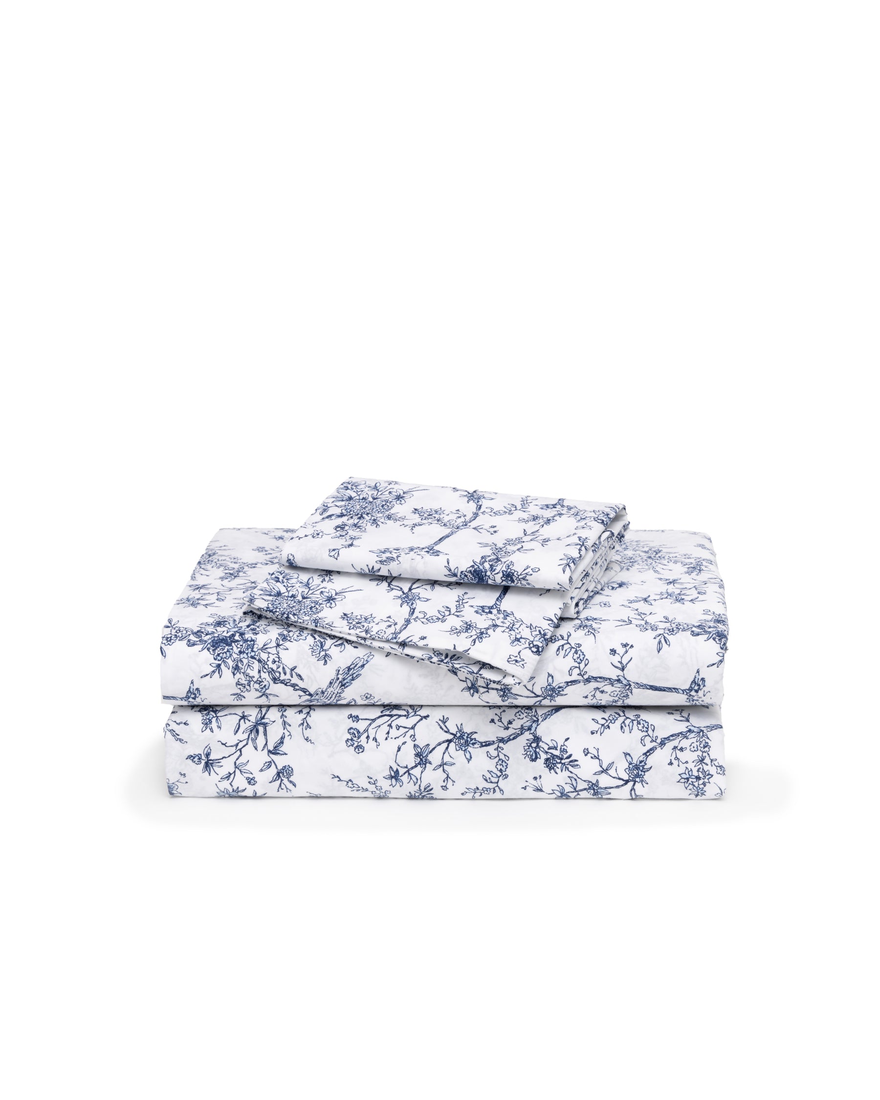 A folded stack of Luxe Premium Cotton Bed Sheets in Timeless Toile by Petite Plume, featuring a blue floral pattern exuding botanical elegance. The set includes a fitted sheet, flat sheet, and pillowcases for luxury bedding on a plain white background.