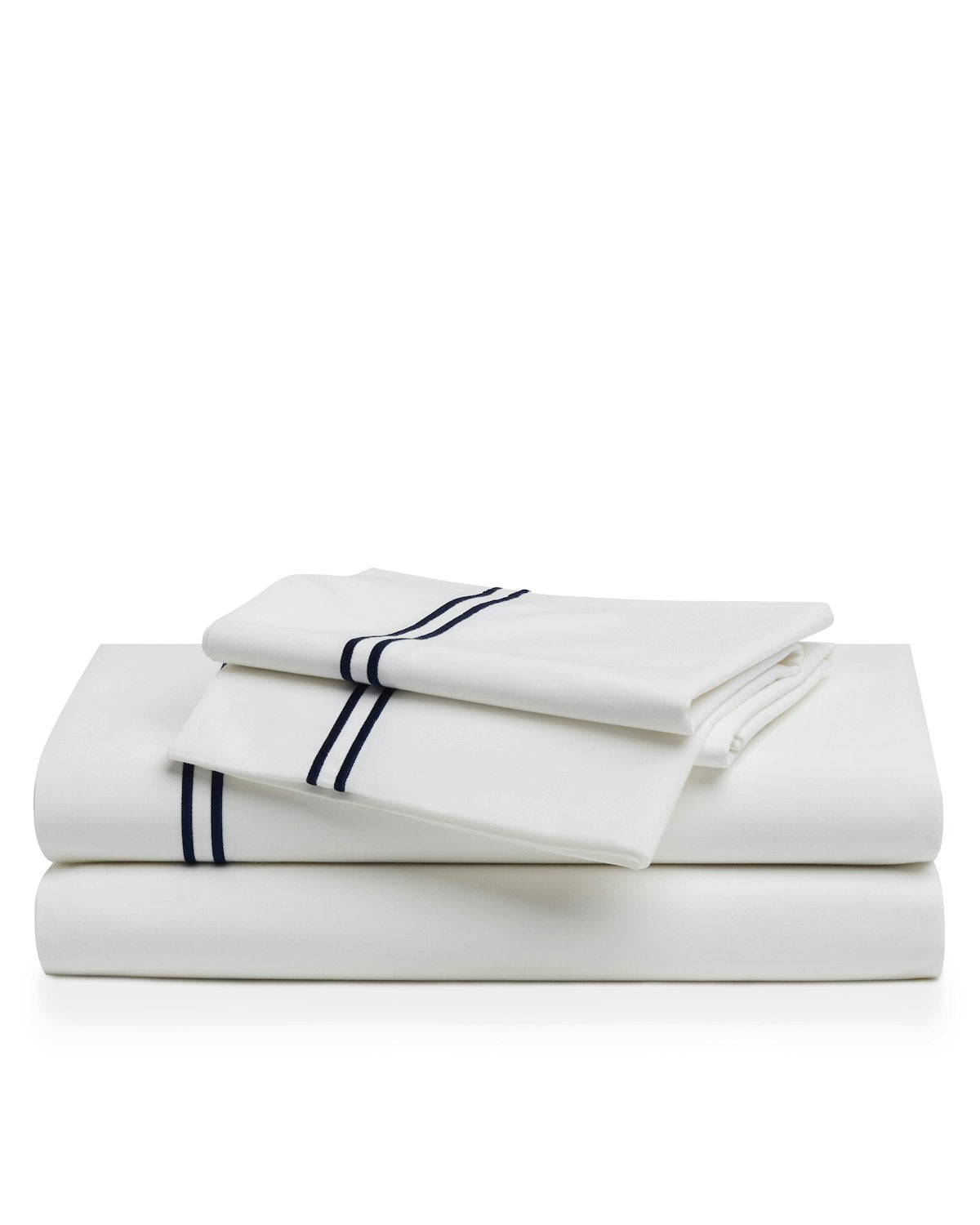 A neatly stacked set of Luxe Premium Cotton Sheets in White with Navy by Petite Plume, featuring two folded white pillowcases on top. Made from long-staple cotton, both pillowcases and sheets showcase two dark blue stripes near the edges against a plain white background.