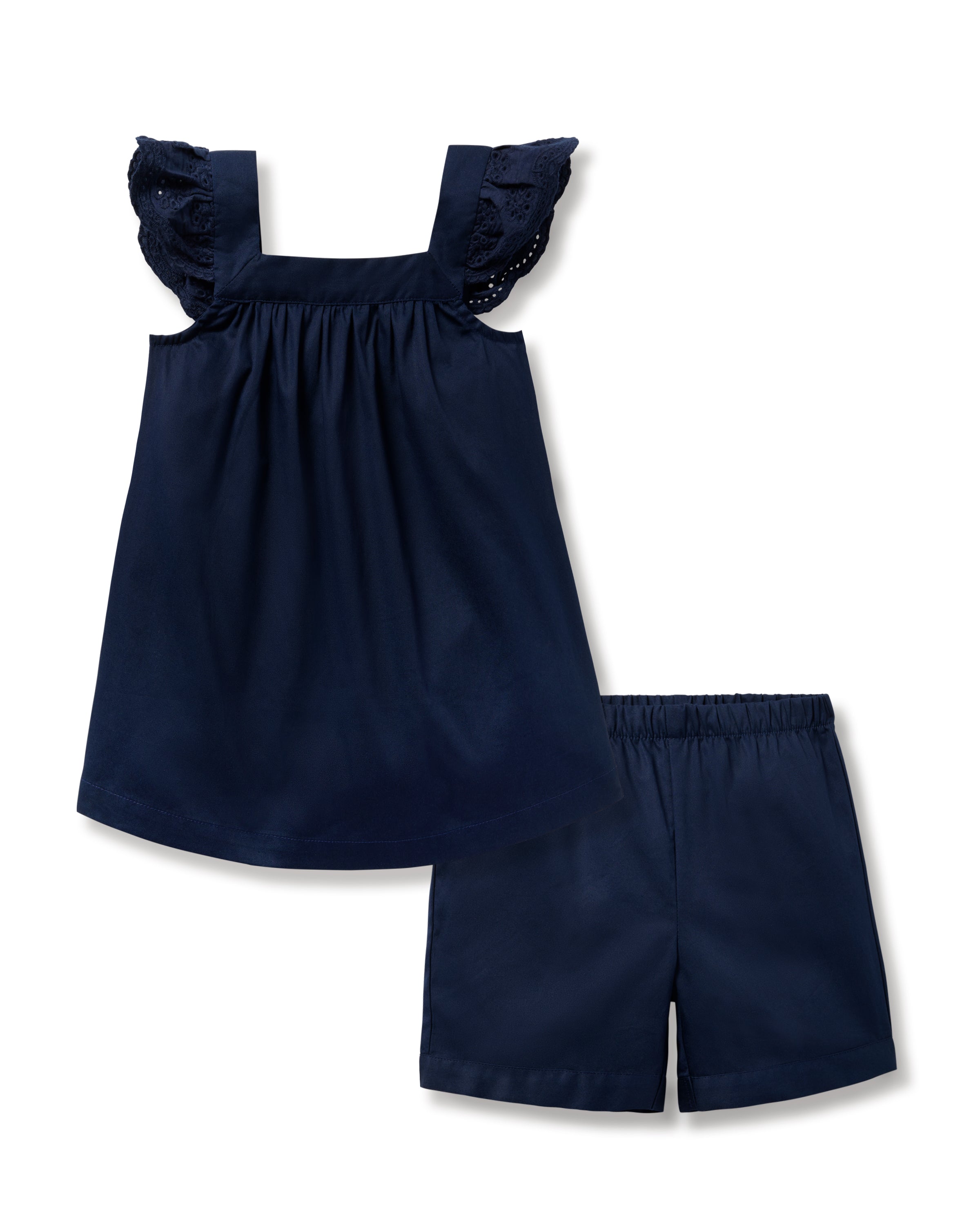 The Girls Twill Clara Short Set in Navy by Petite Plume is crafted from top-quality cotton and includes a sleeveless dress with ruffled straps and matching shorts. This breezy set has a loose fit, with the dress gathered at the top and elastic waistband shorts against a plain white background.