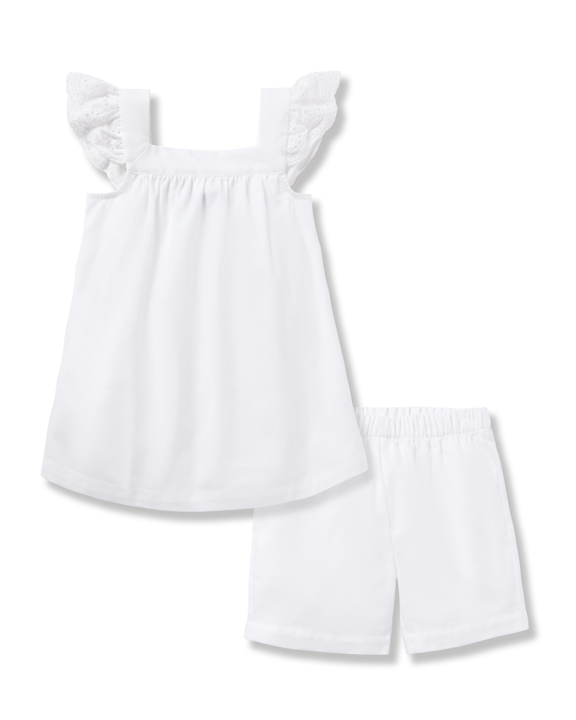 The Girls Twill Clara Short Set in White by Petite Plume features a soft cotton dress with lace frill straps, complemented by matching white shorts with an elastic waistband for comfort.