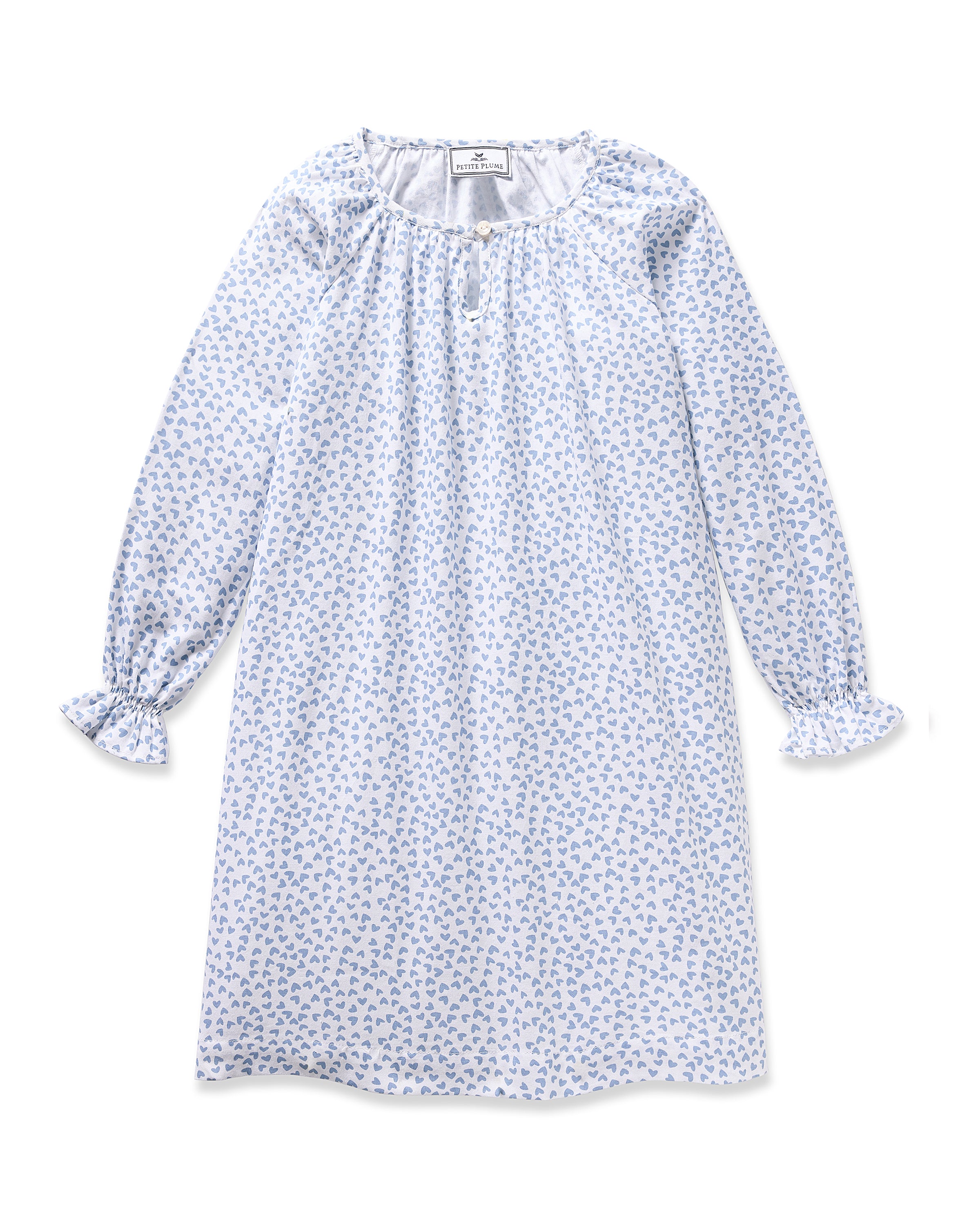 The Girls Twill Delphine Nightgown in Bluehearts by Petite Plume offers luxurious sleepwear with long sleeves, a blue and white floral design, elastic cuffs featuring ruffles, and a gathered neckline accented by a small bow, ideal for fans of elegant comfort.