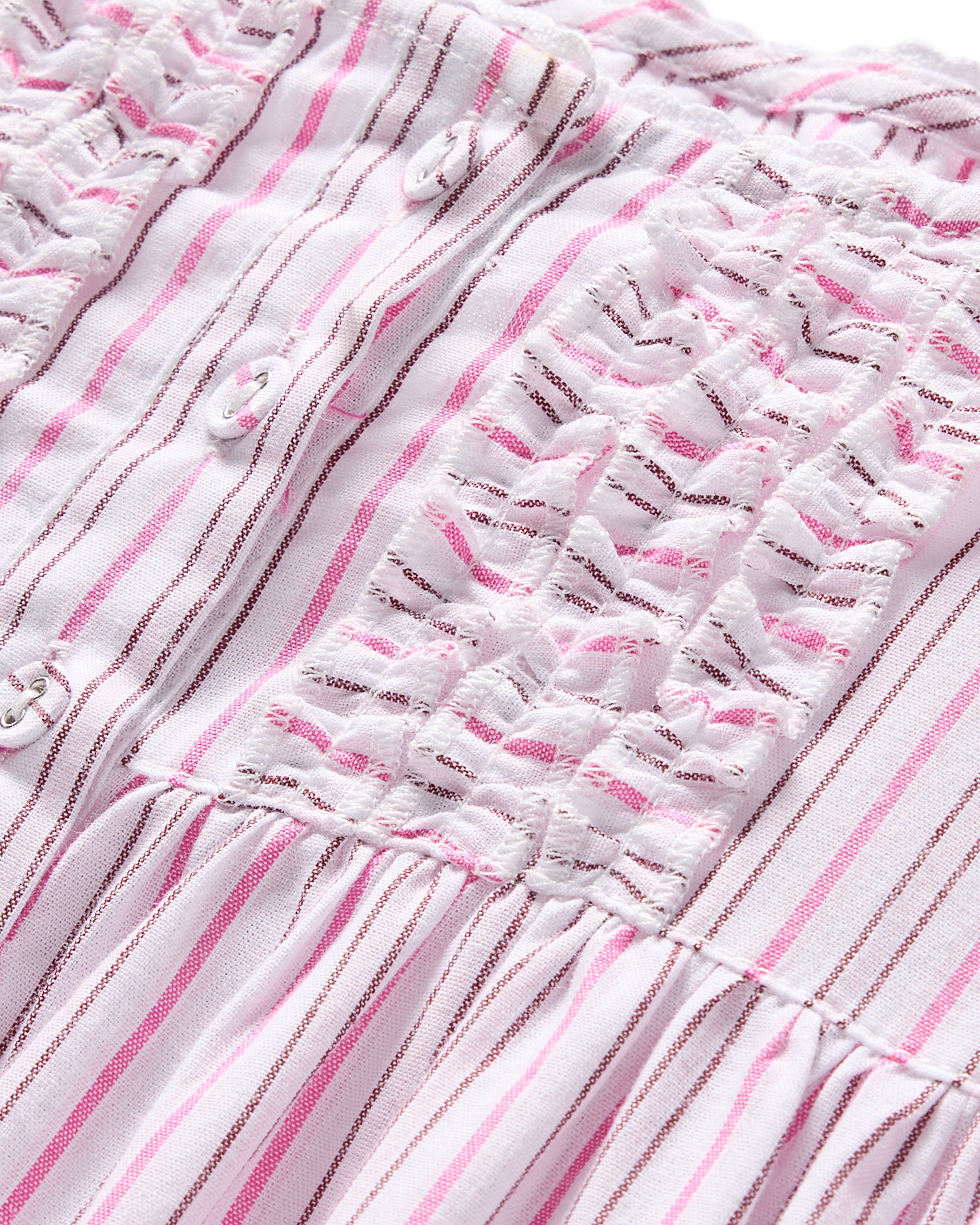 Close-up of the Girls Twill Charlotte Nightgown in Blush Boulevard by Petite Plume. It features vertical pink and white stripes, ruched detailing, and small white buttons, giving it texture and style. The lightweight cotton fabric adds a summery feel to this sleepwear piece.