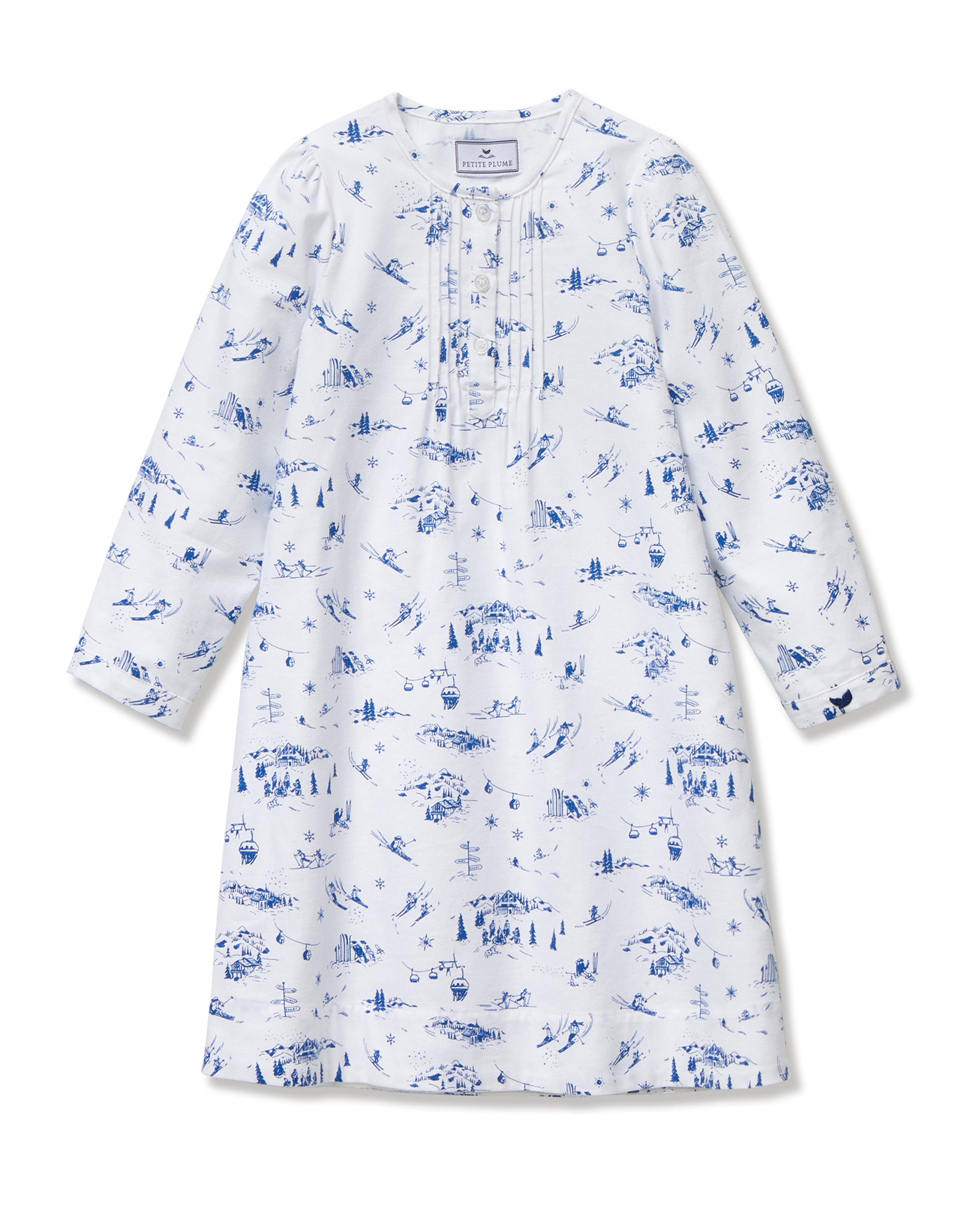 The Girl's Twill Beatrice Nightgown in Chalet Toile features long sleeves, knee-length, white fabric with blue scenic prints, a round neckline, pintucks on the chest, a loose fit, and button details at the neck.