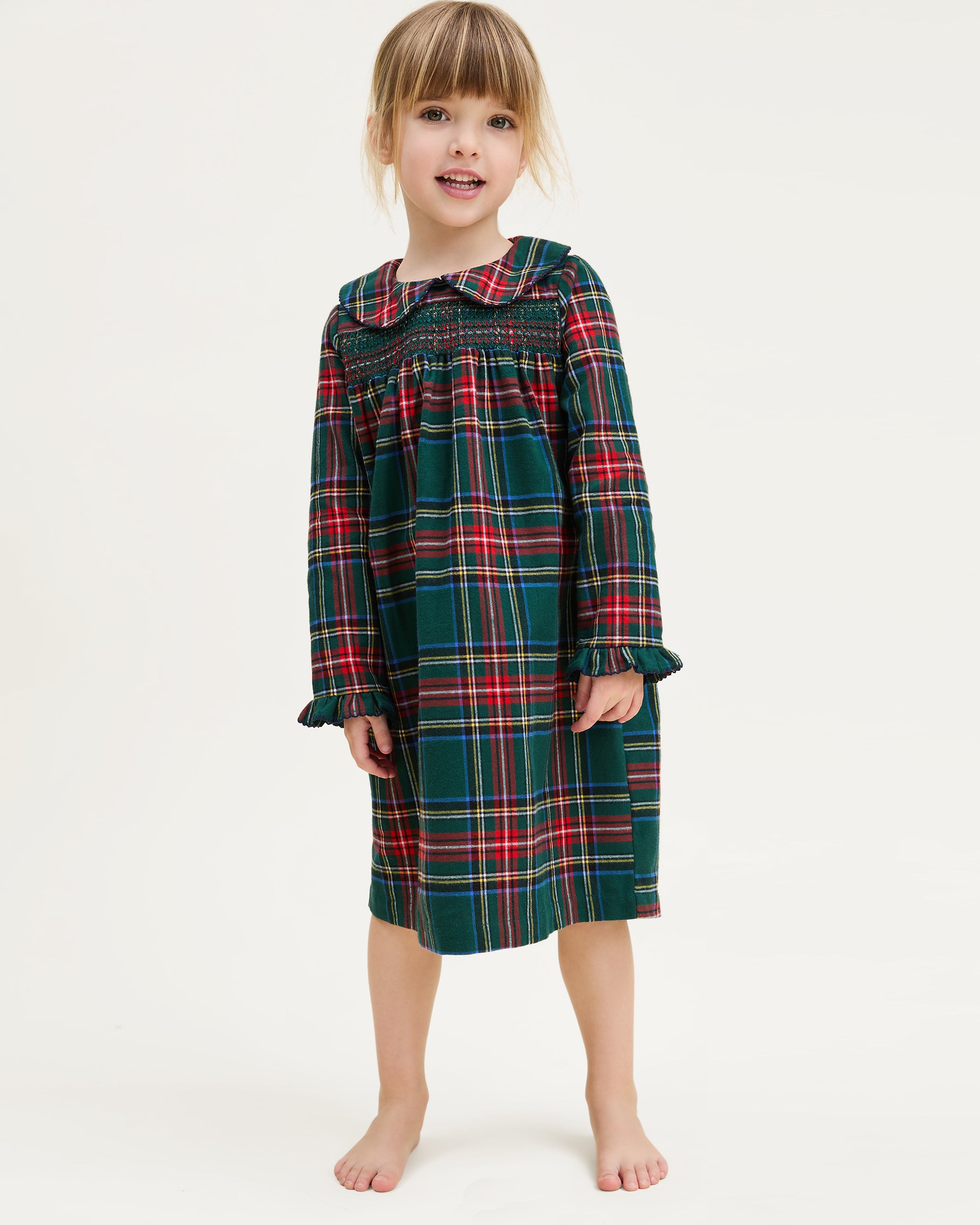 The Girl's Brushed Twill Eloise Nightgown in Kensington Tartan features a green, red, and yellow plaid pattern with long sleeves, a Peter Pan collar, smocked chest, and ruffled cuffs.