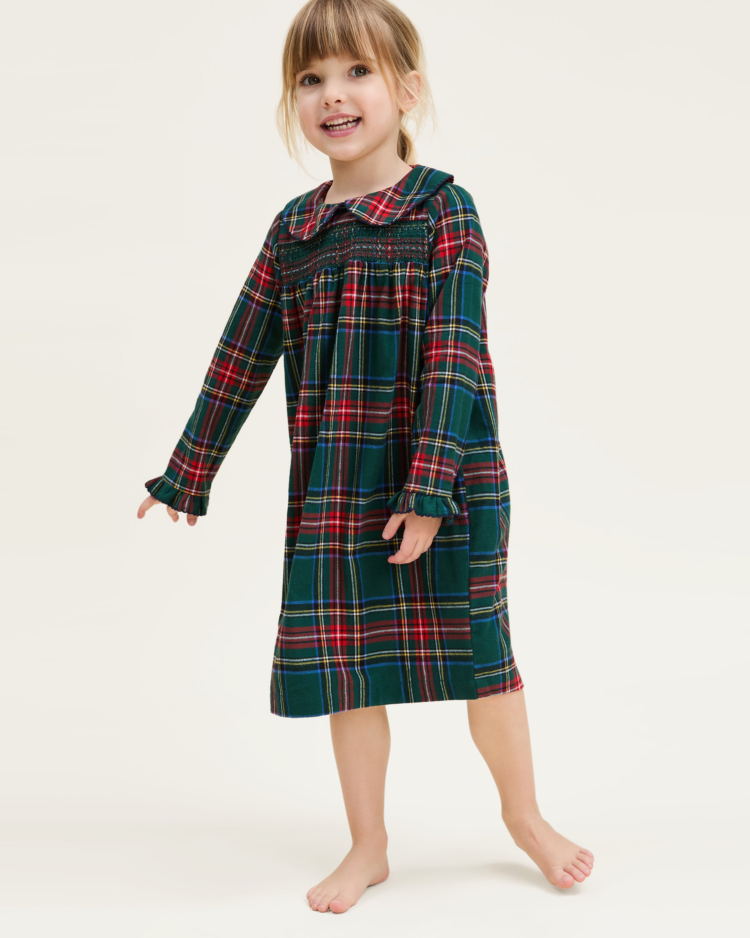 The Girl's Brushed Twill Eloise Nightgown in Kensington Tartan features a green, red, and yellow plaid pattern with long sleeves, a Peter Pan collar, smocked chest, and ruffled cuffs.