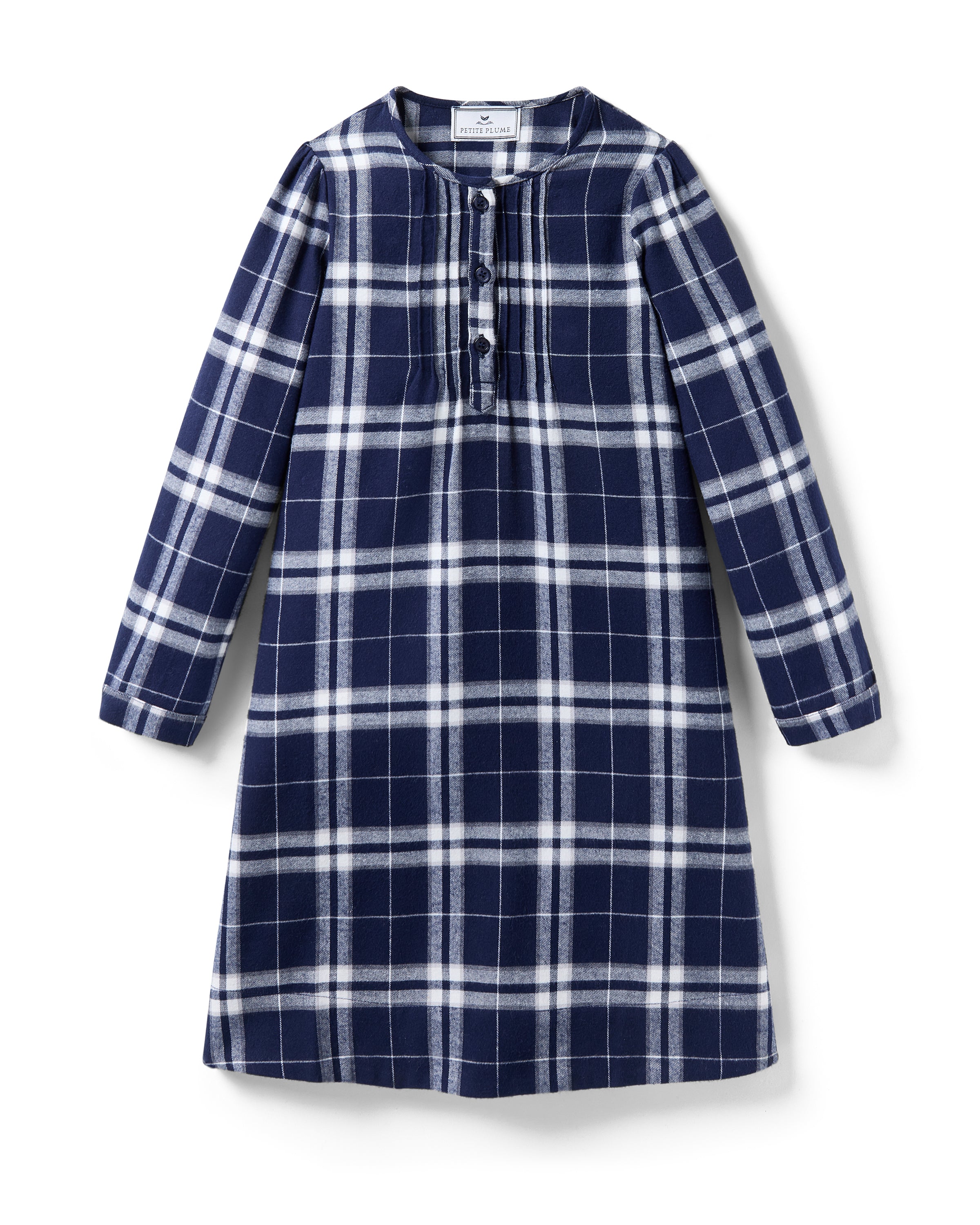 The Girl's Brushed Twill Beatrice Nightgown in Oxford Tartan features a navy, white, and gray plaid pattern, long sleeves, a round neckline, front buttons, and pleats near the chest.