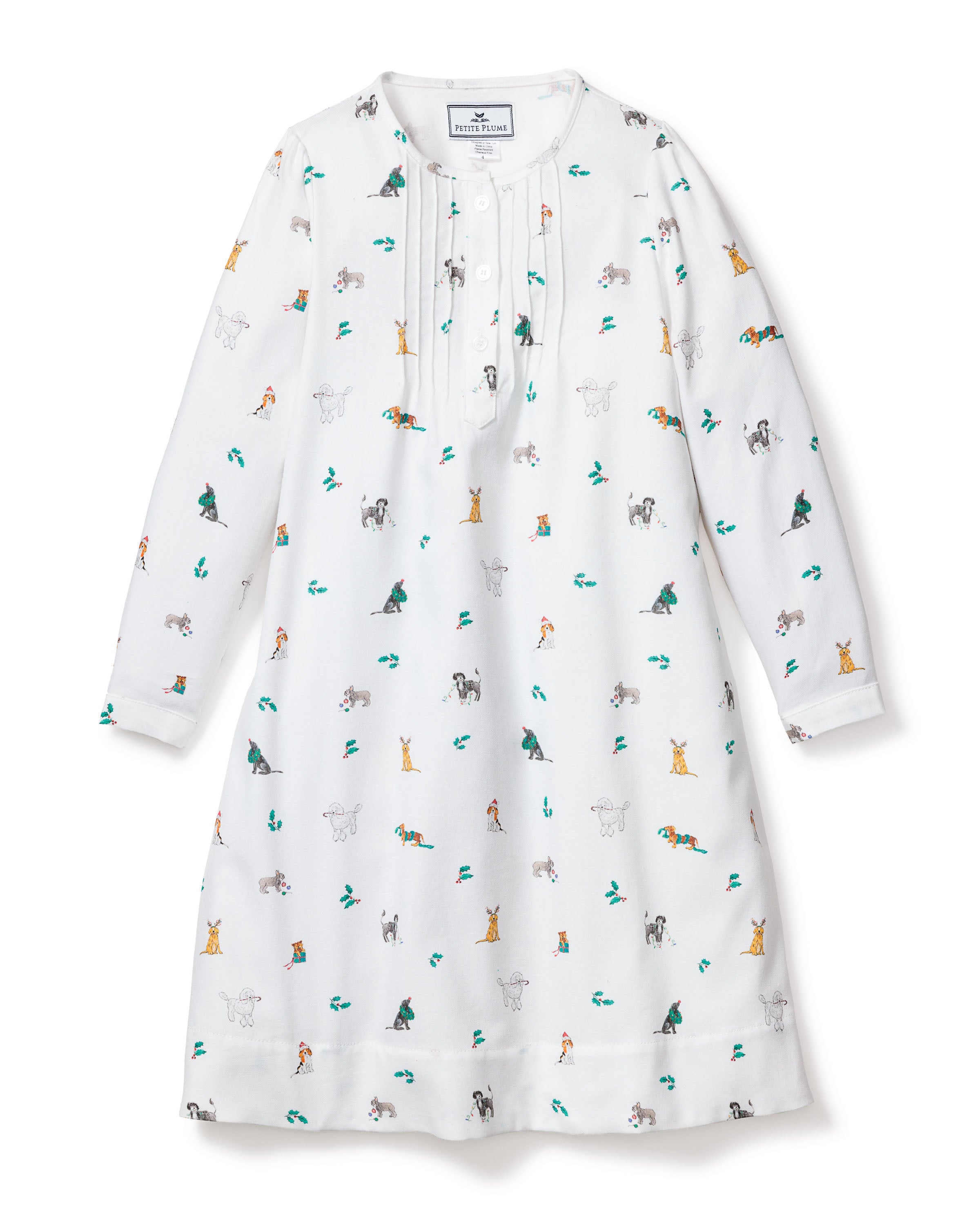The Girls Twill Beatrice Nightgown in Jingle Paws by Petite Plume is a white, long-sleeved gown with colorful playful dogs. It features a buttoned neckline and straight-cut hem, crafted from chemical-free flame-retardant fabric for luxurious comfort and safety in childrens sleepwear.