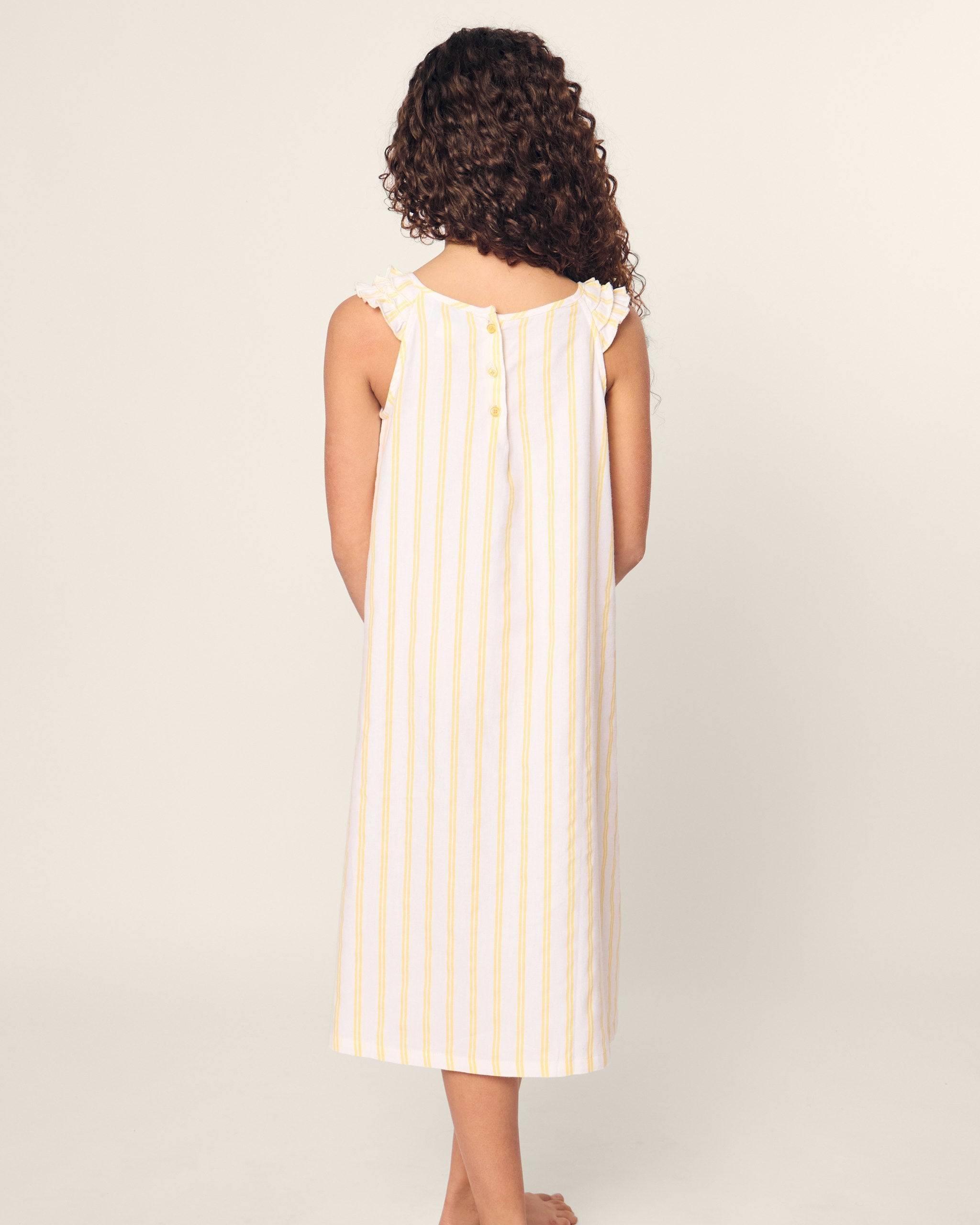 White sleeveless dress with yellow vertical stripes on a white background