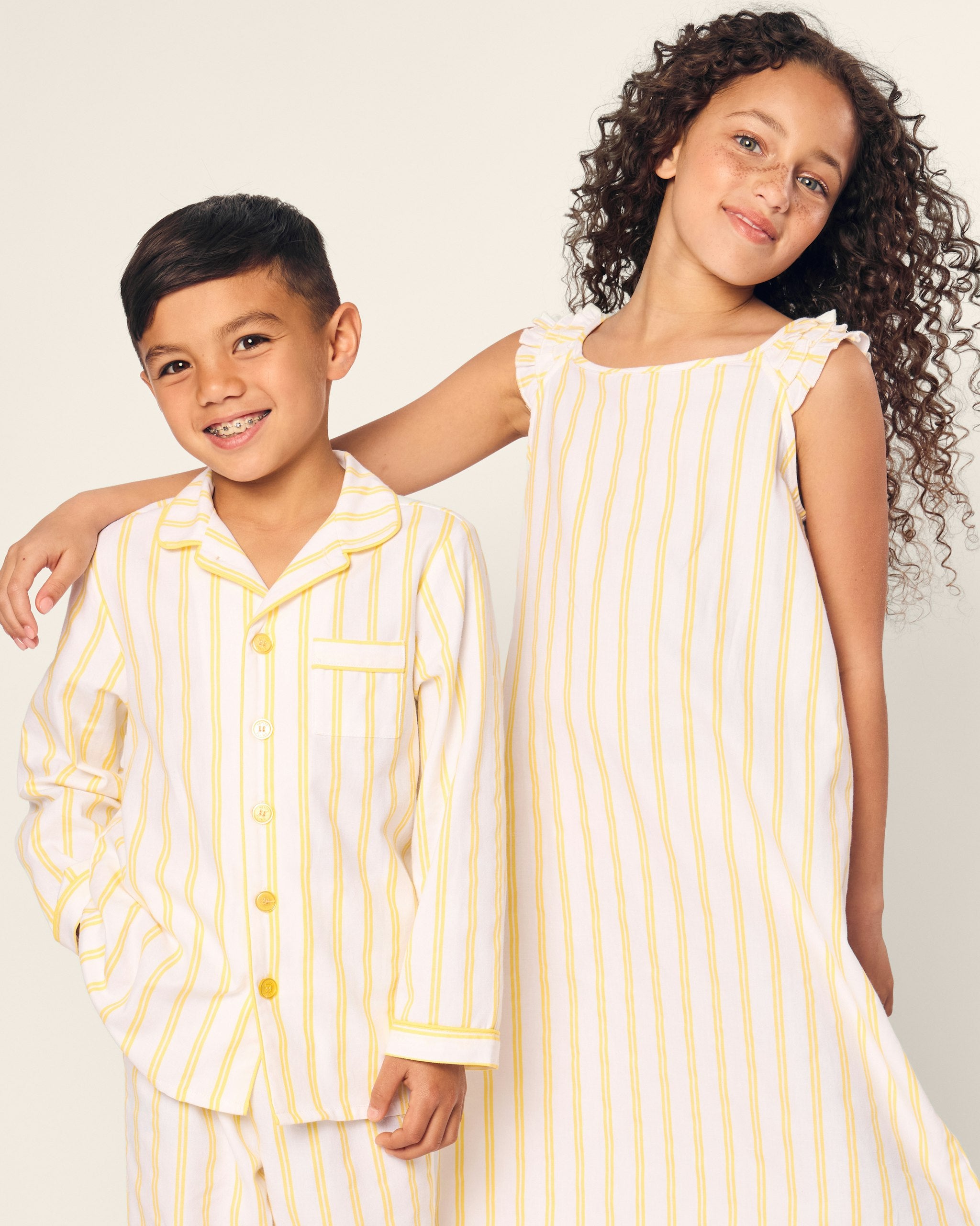 White sleeveless dress with yellow vertical stripes on a white background