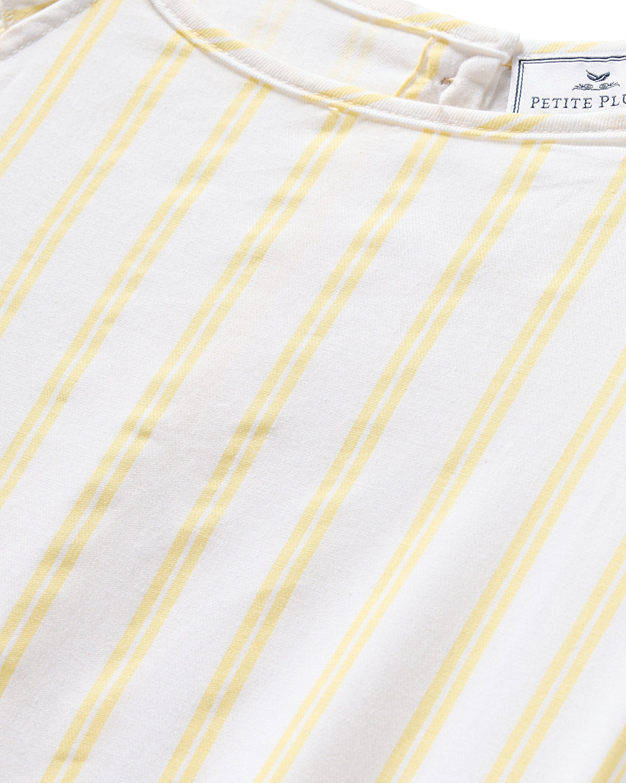 White sleeveless dress with yellow vertical stripes on a white background