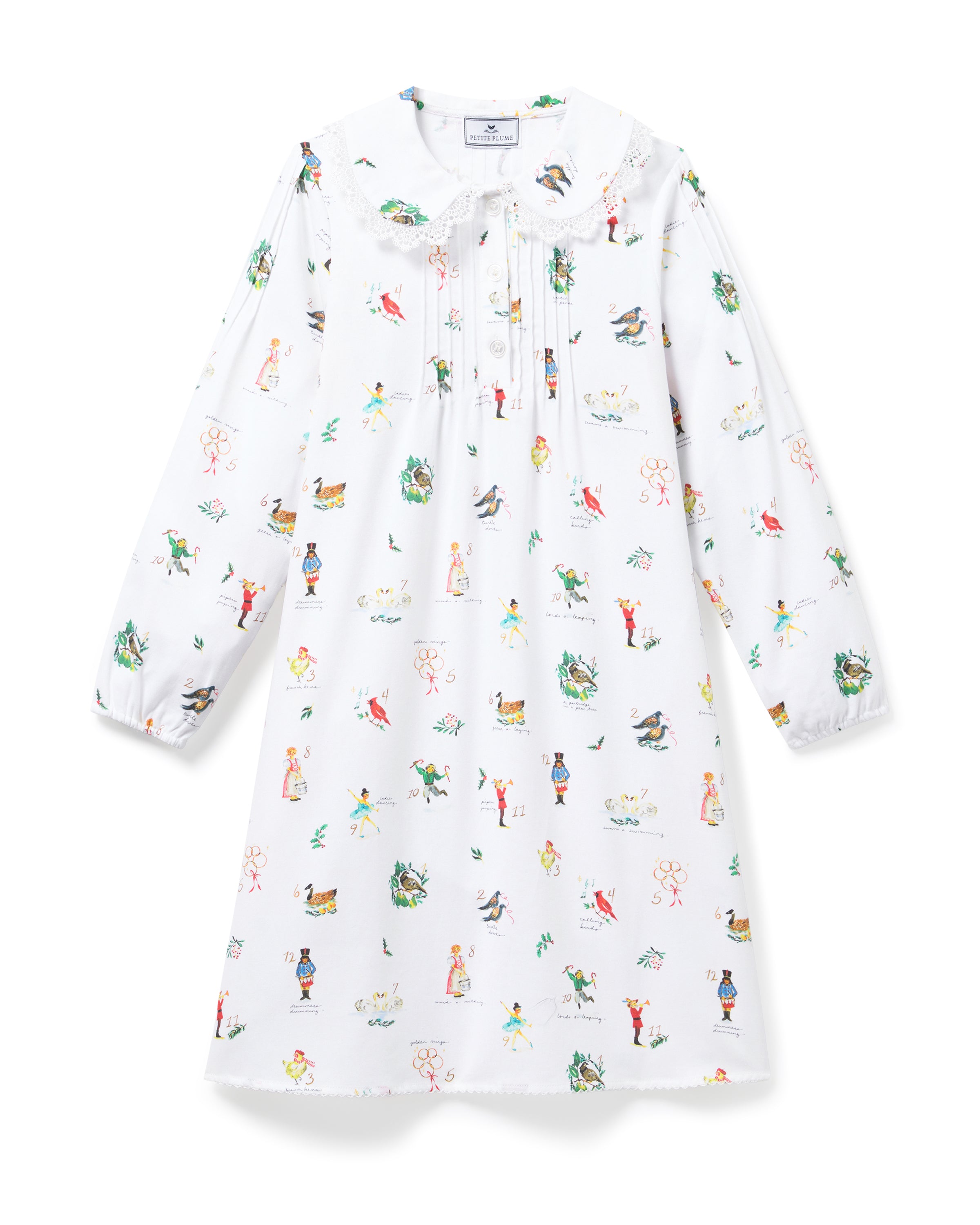 The Girl's Twill Lola Nightgown in 12 Days of Christmas is a white long-sleeve children’s dress with a Peter Pan collar and a playful pattern of colorful people, animals, and plants scattered across the fabric.