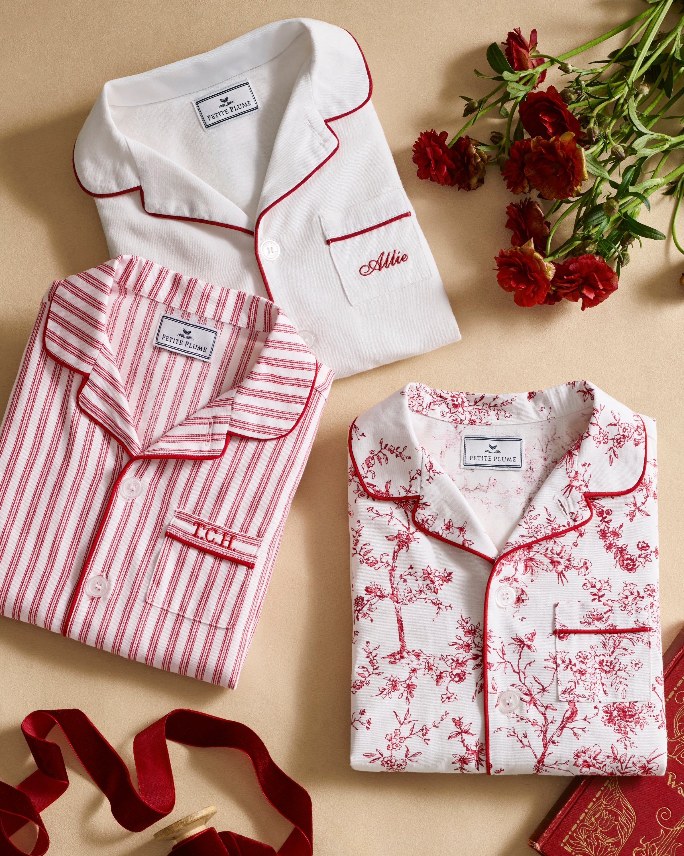The Kid's Twill Pajama Set in Red Timeless Toile features a white base with red toile print, long-sleeve button-up top with front pocket, matching pants, and red piping accents.