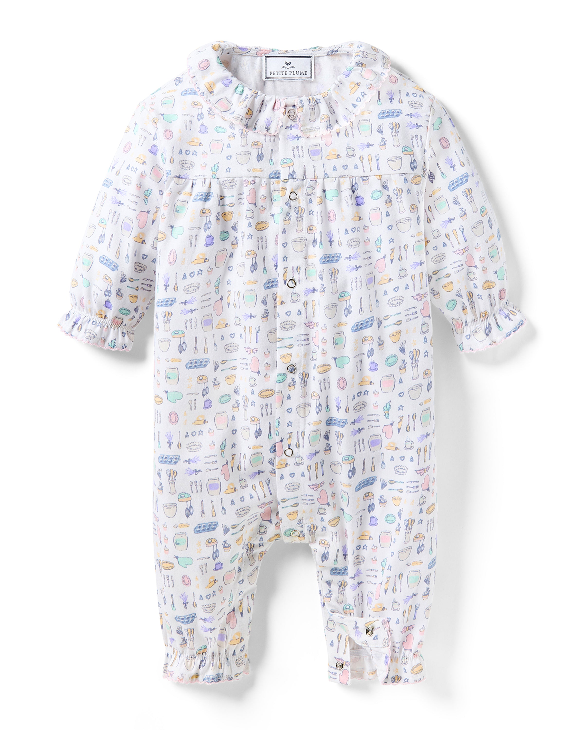 The Baby's Twill Madeline Romper in Baking Spirits Bright features long sleeves, a ruffled collar and cuffs, pastel kitchen print on white, front buttons, and snap closures at the legs for easy dressing.