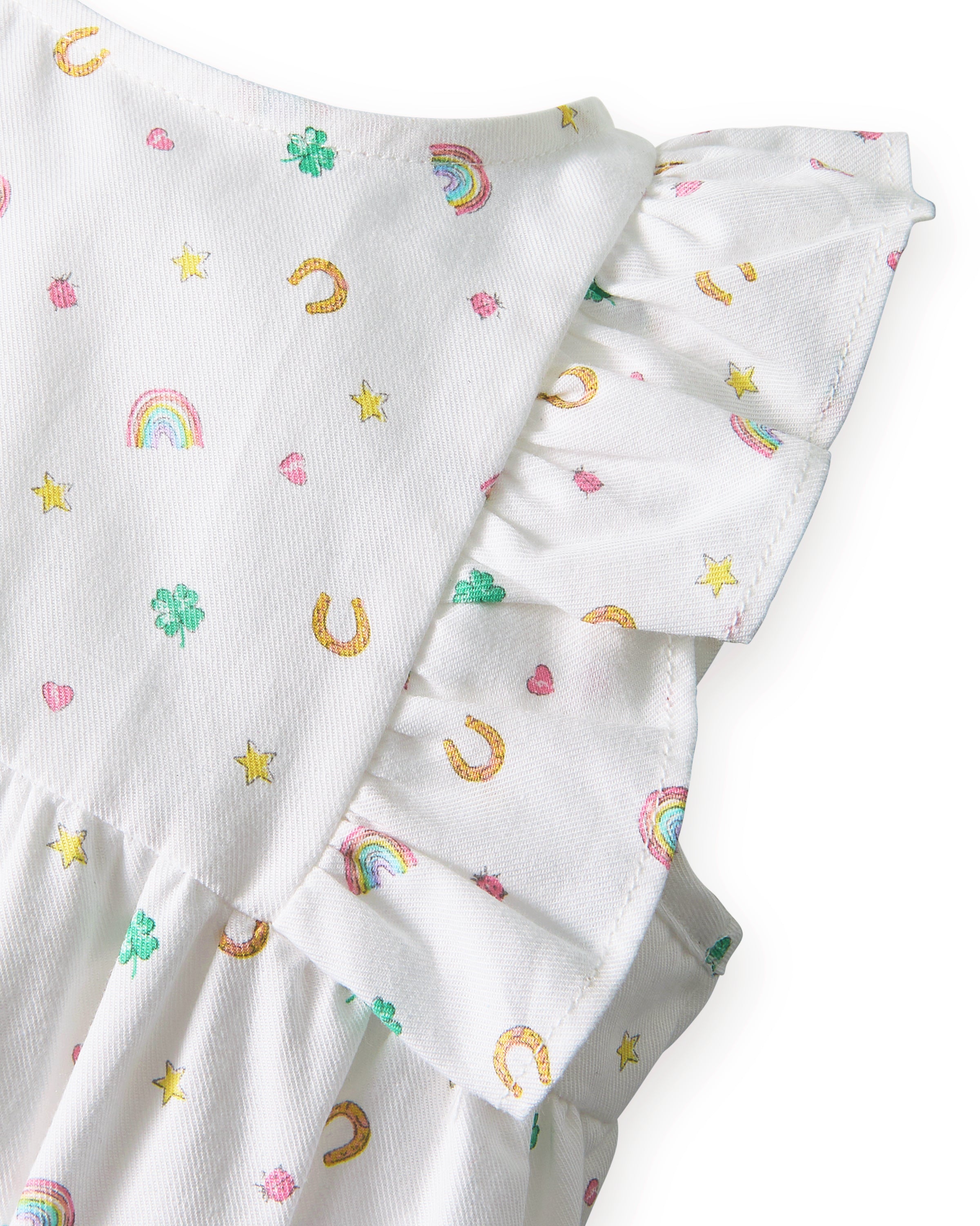 Baby's Twill Ruffled Romper in Good Luck Charms features small colorful prints of rainbows, horseshoes, clovers, and stars, ruffled sleeves, elastic leg openings, and a tag at the neckline.