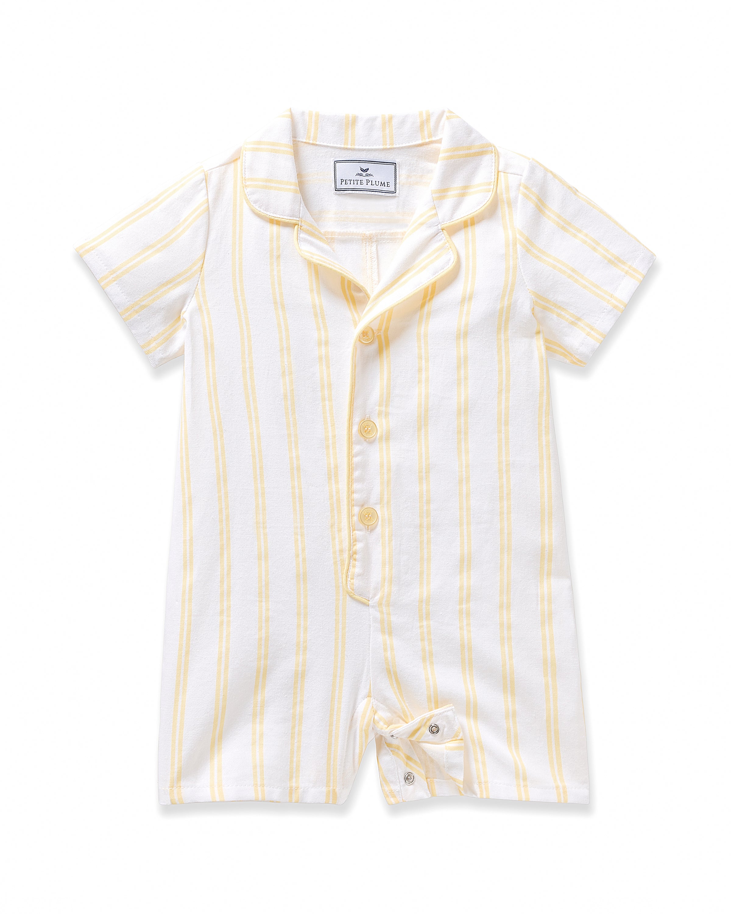 The Babys Twill Summer Romper in Sunny Stripe by Petite Plume features short sleeves, a collar, and is made from yarn-dyed cotton with yellow stripes on white. It has a front button closure and a small tie at the bottom for added charm.