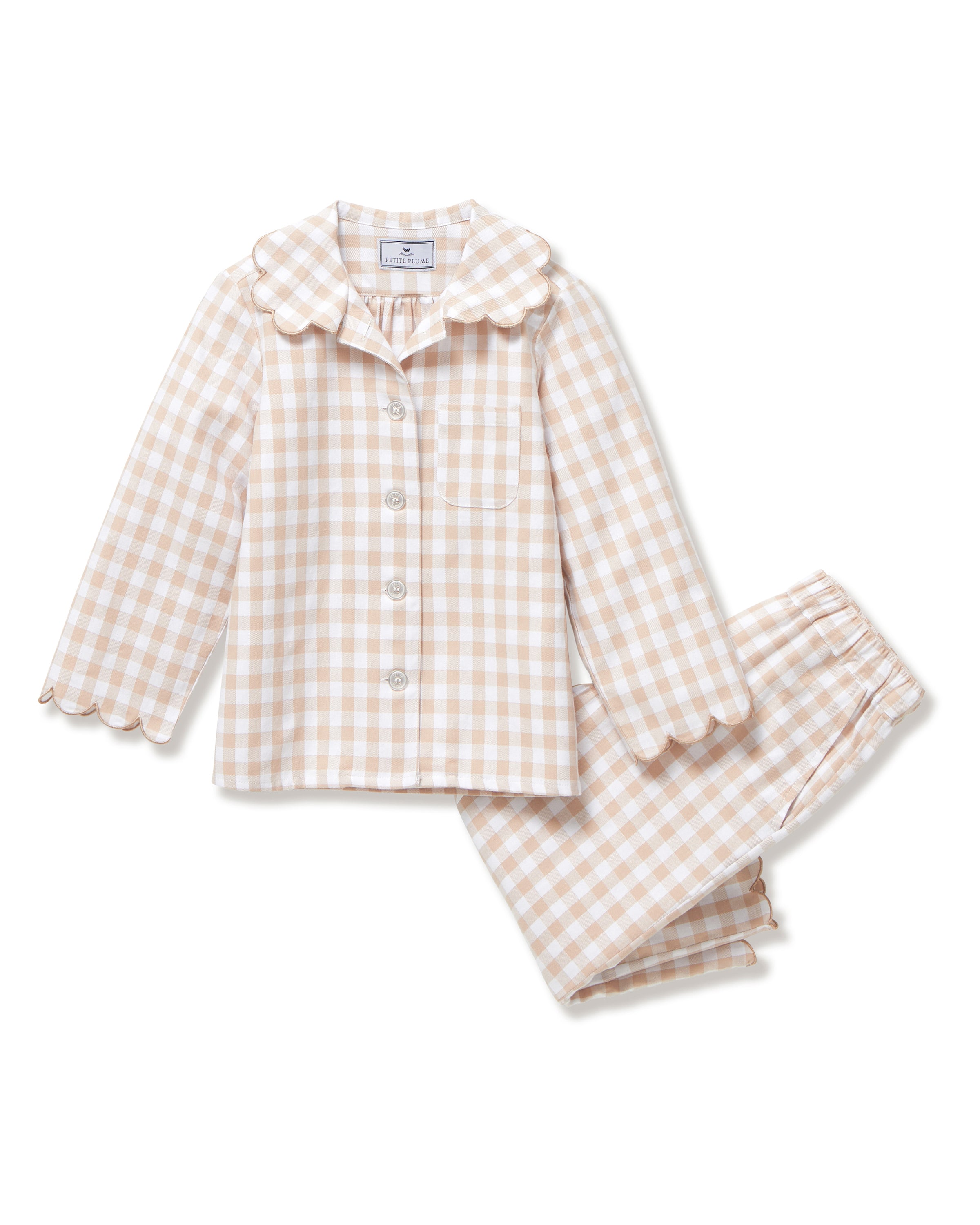 Kid's Twill Colette Pajama Set in Camel Gingham, featuring a beige and white gingham pattern with a scalloped collar, long sleeves, front pocket, and matching elastic-waist pants, is displayed neatly on a white background.