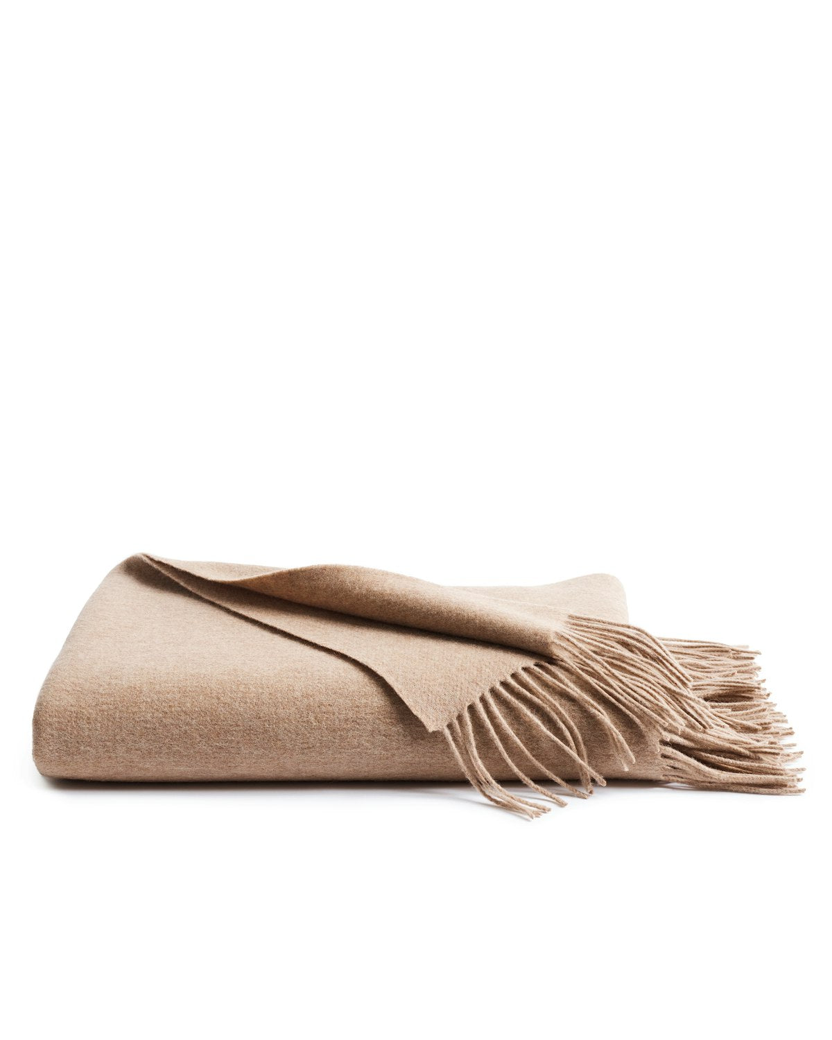 The Petite Plume Cashmere Fringe Throw in Beige, with its luxurious softness and elegant fringe edges, is folded neatly against a white backdrop—an ideal addition to your home decor.