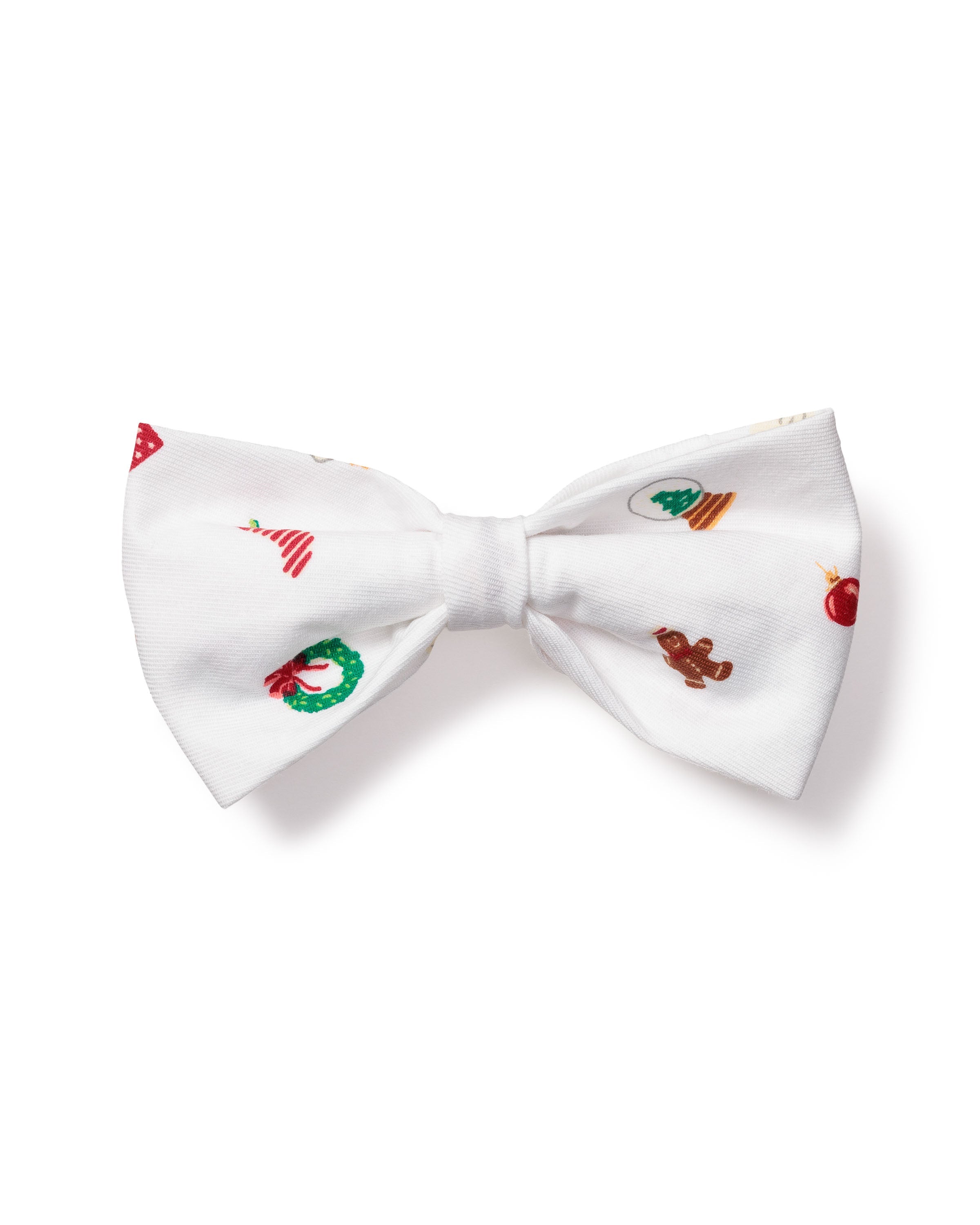 The Petite Plume Dog Twill Bow Tie in Winter Nostalgia features a charming white design with festive patterns of Christmas trees, wreaths, gingerbread men, and ornaments.