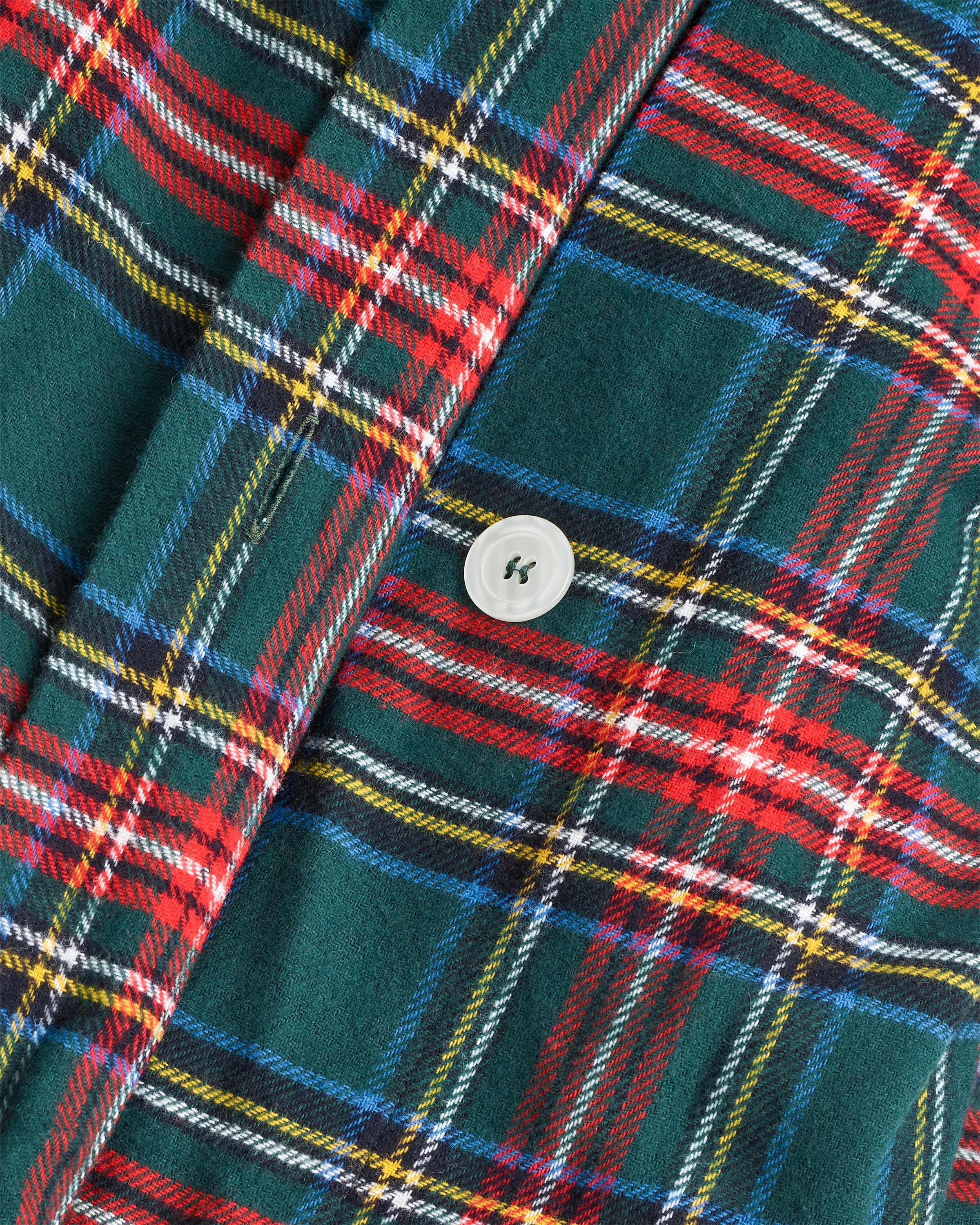 The Flannel Duvet Set in Kensington Tartan features a green, red, and white plaid pattern and includes a comforter and two pillows, all neatly folded against a white background.