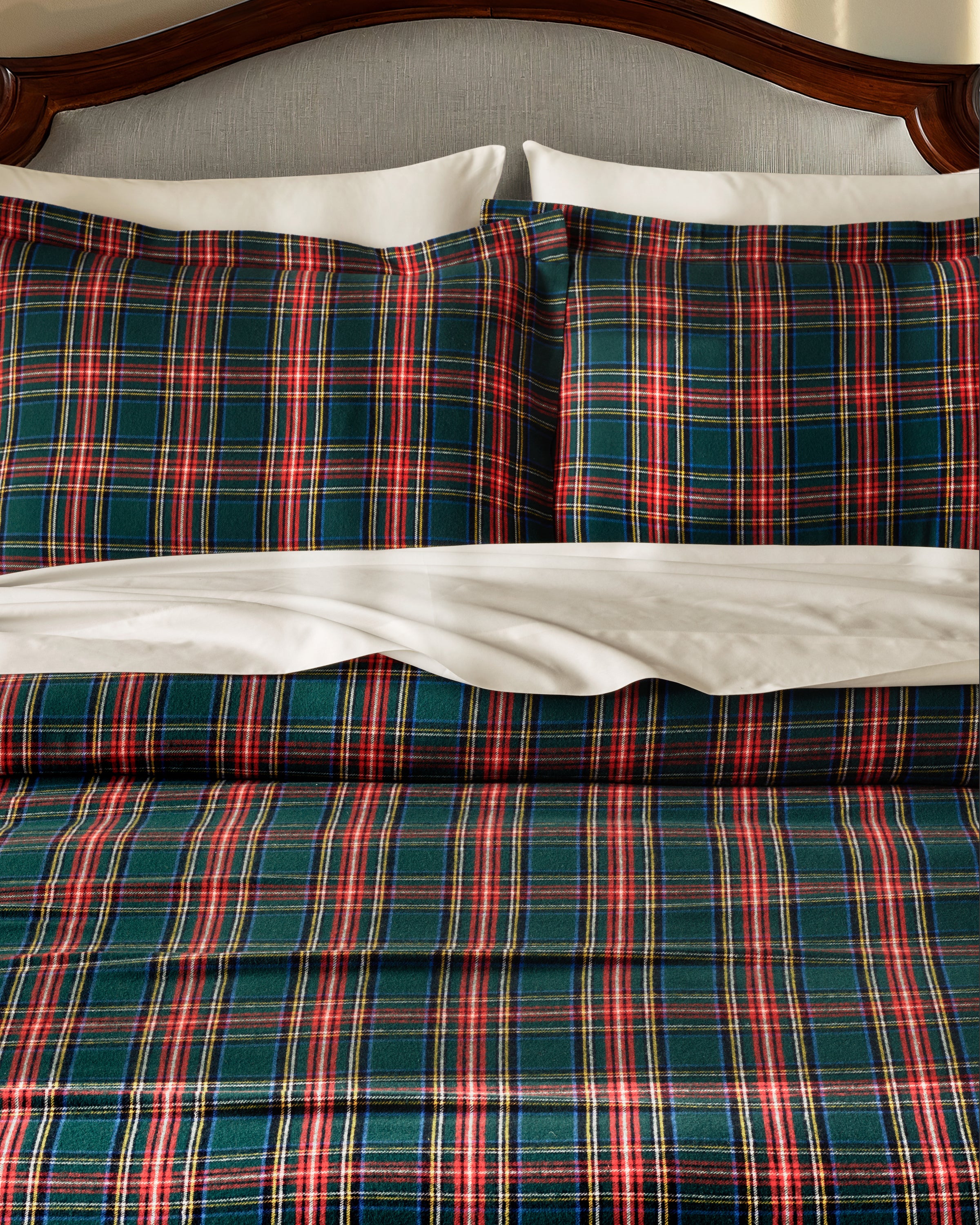 The Flannel Duvet Set in Kensington Tartan features a green, red, and white plaid pattern and includes a comforter and two pillows, all neatly folded against a white background.
