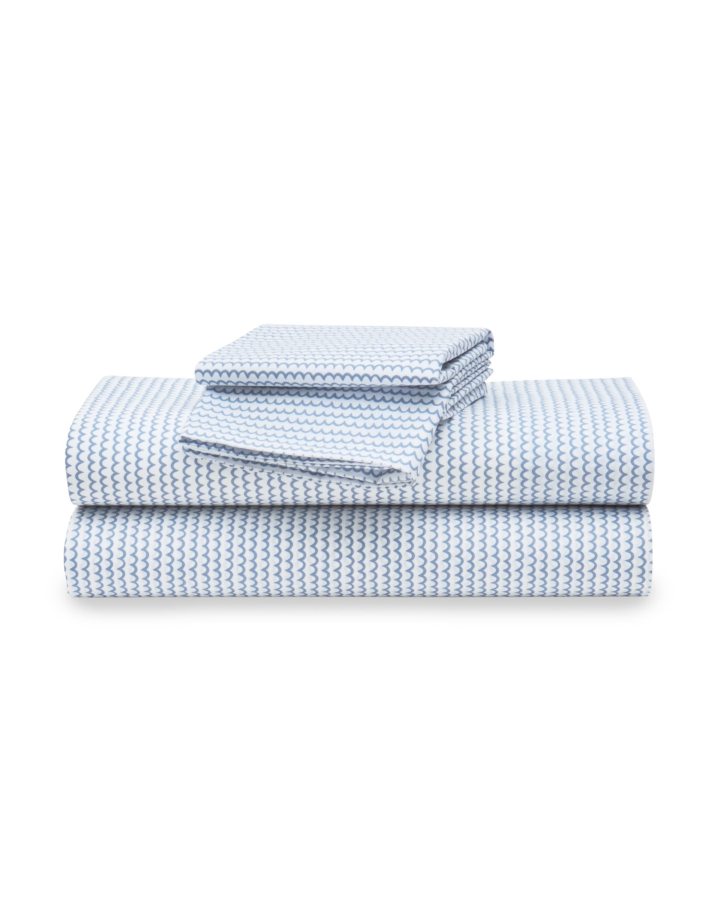 The Luxe Premium Cotton La Mer Bed Sheets by Petite Plume, featuring breathable blue and white percale sheets and pillowcases, are neatly stacked against a plain white background.