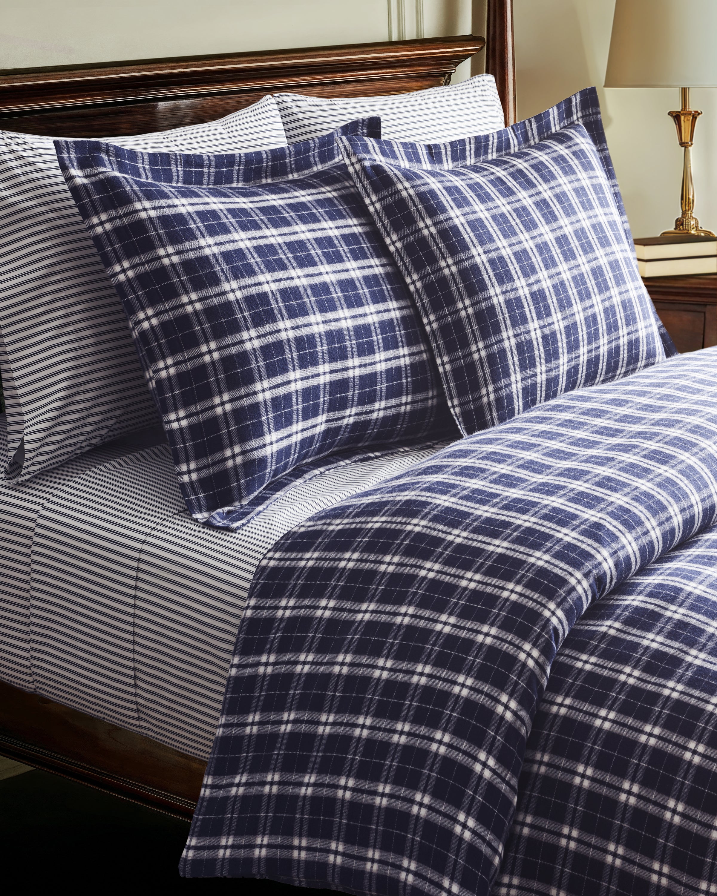 The Flannel Duvet Set in Oxford Tartan features a neatly folded blue and white plaid comforter with two matching pillowcases stacked on top, displayed against a plain white background.