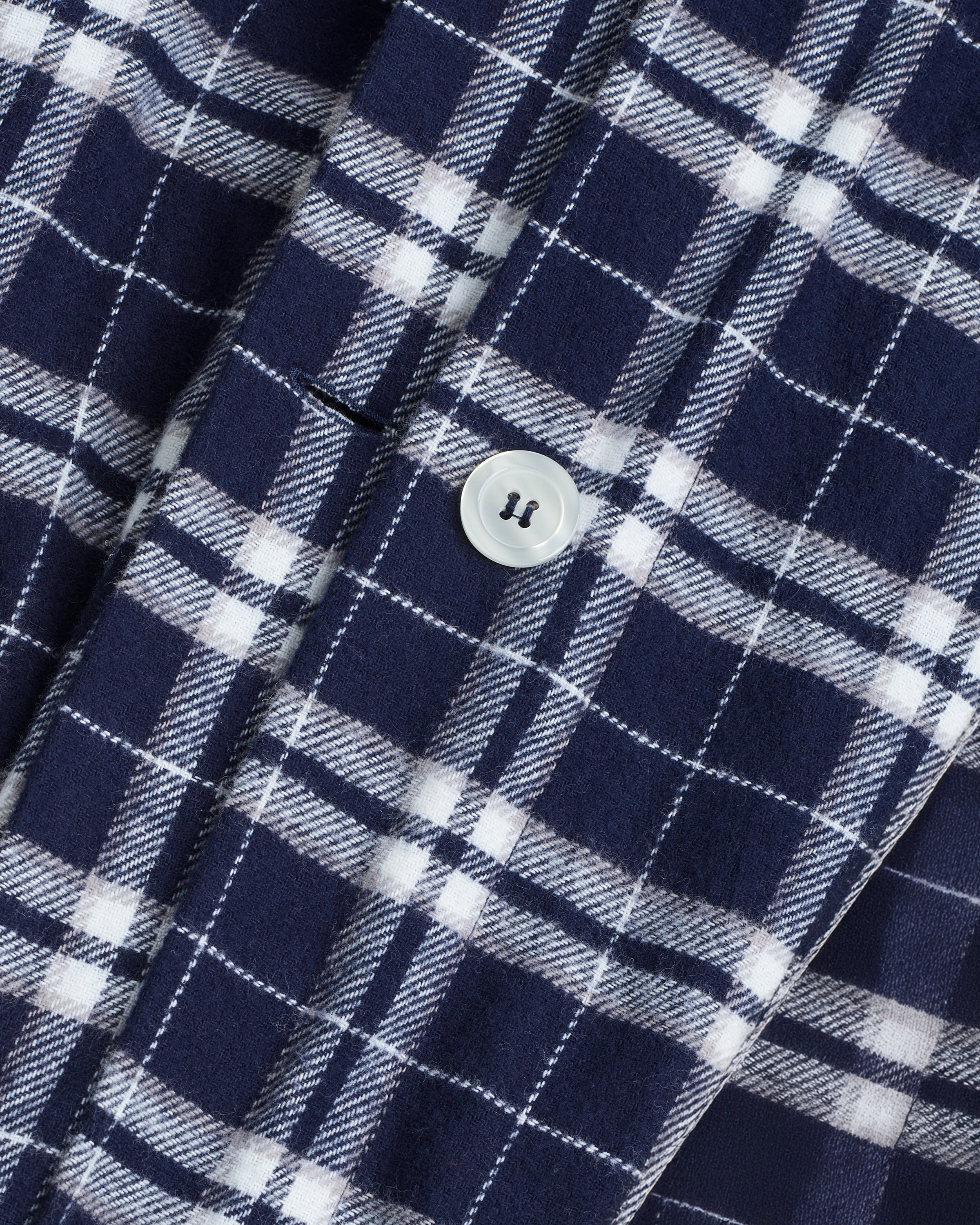 The Flannel Duvet Set in Oxford Tartan features a neatly folded blue and white plaid comforter with two matching pillowcases stacked on top, displayed against a plain white background.