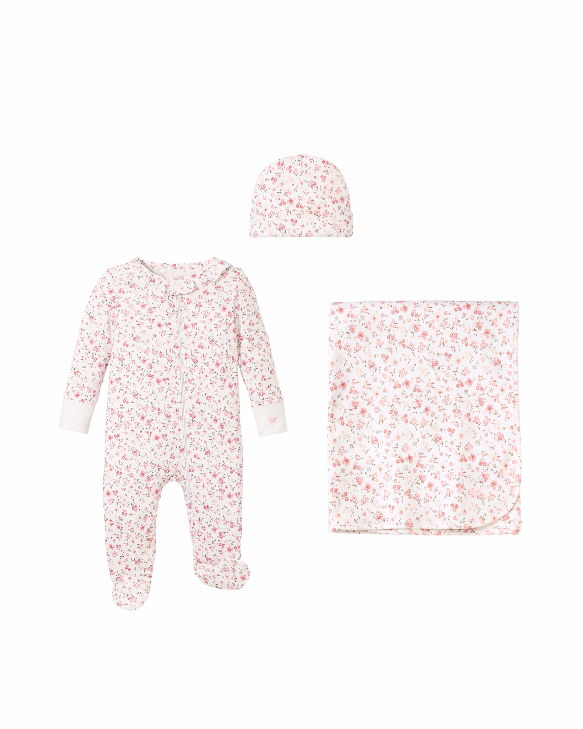 The Welcome Home Baby Set - Dorset Floral by Petite Plume includes a charming romper with full-length sleeves and legs, a matching hat, and cozy blanket, all featuring a pink floral design. The delightful set is beautifully presented on a plain white background.