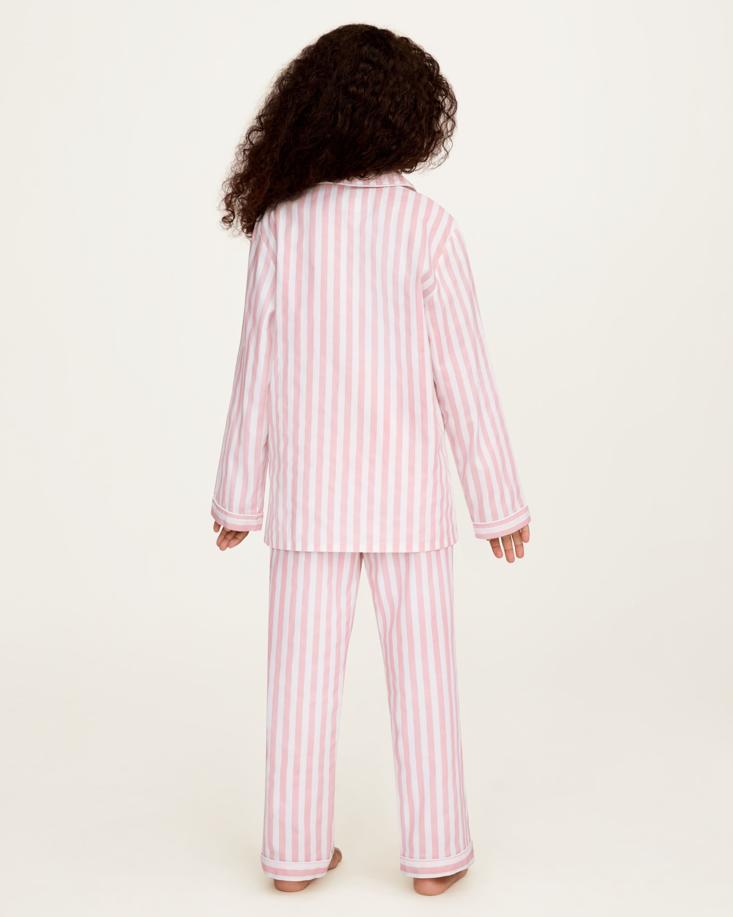 Petite Plume x Eloise Kid's Twill Pajama Set in Eloise Classic Stripe features pink and white stripes.