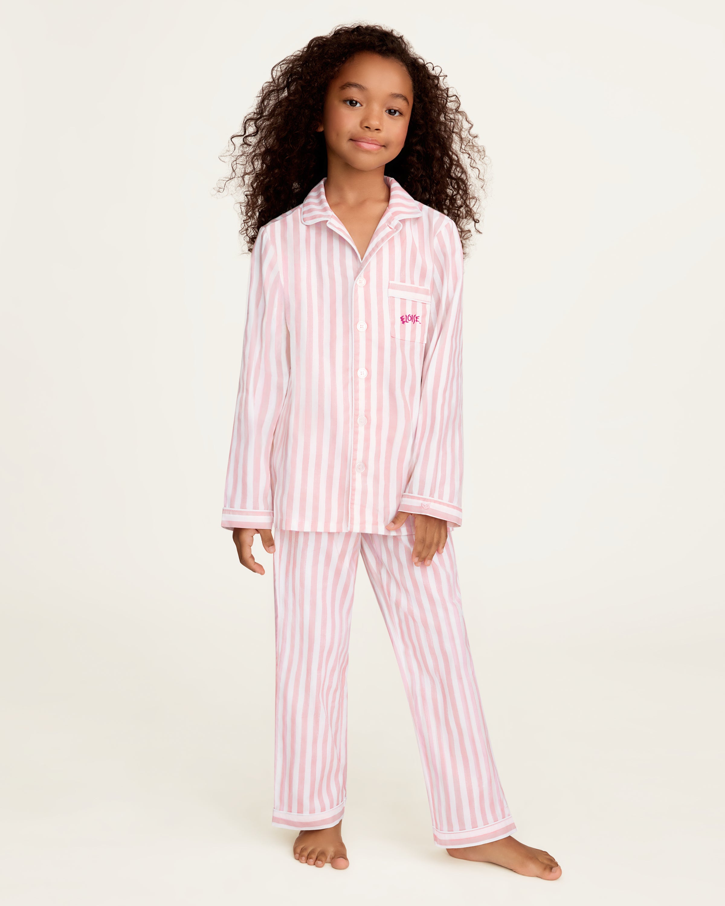 Petite Plume x Eloise Kid's Twill Pajama Set in Eloise Classic Stripe features pink and white stripes.