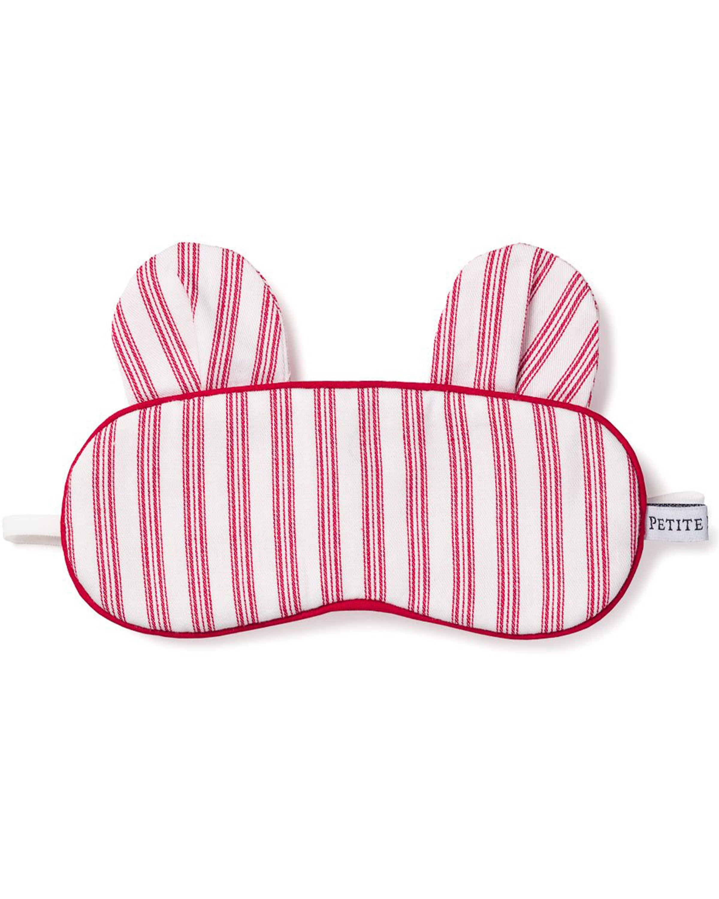 The Kids Bear-y Sleep Mask in Antique Red Ticking from Petite Plume features charming bunny ear-shaped accents and red borders. Its perfect for enhancing your eye mask collection or pairing with monogrammed sleepwear for an exquisite nights rest.