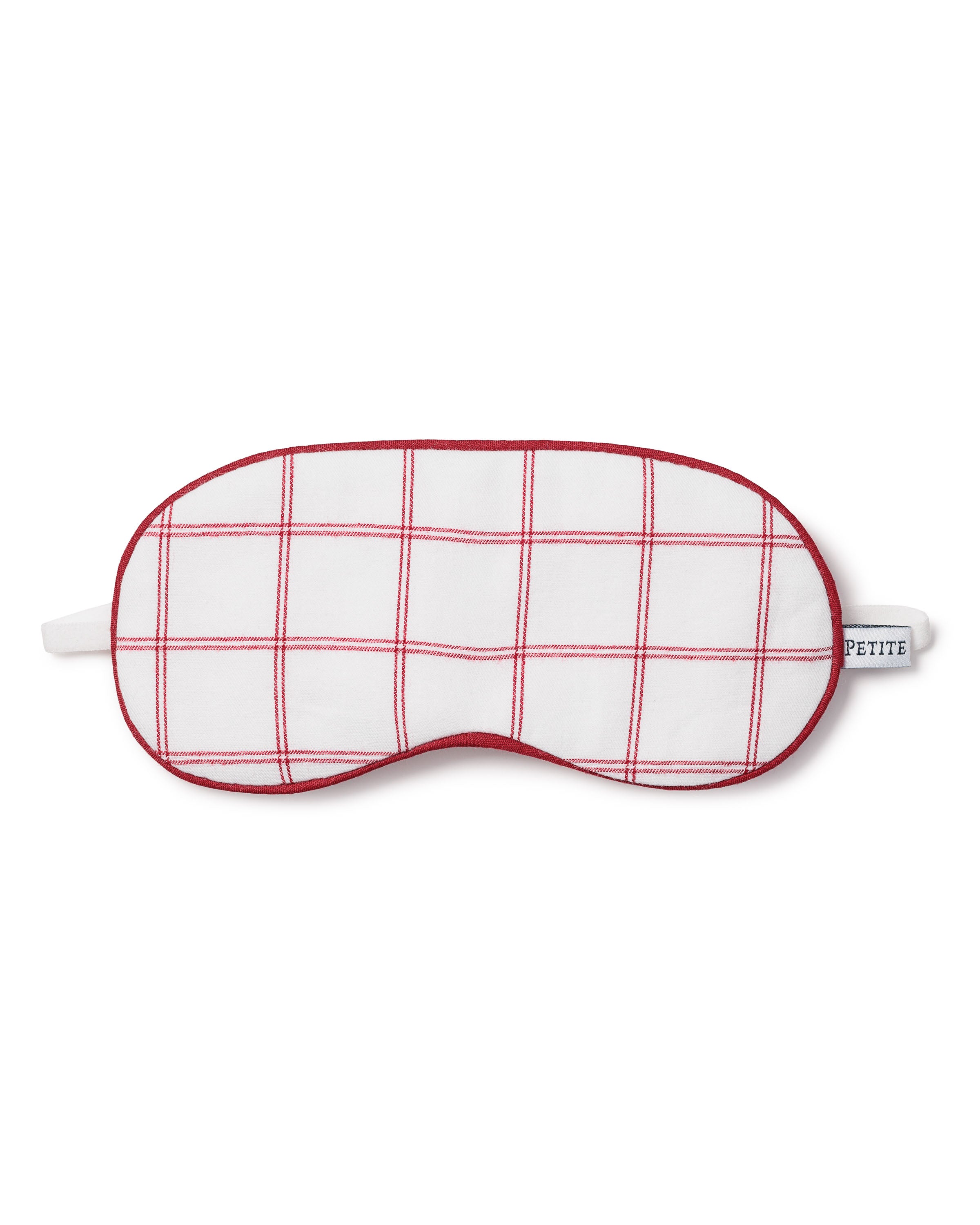 The Kids Twill Sleep Mask in Garnet Tattersall by Petite Plume features a red grid pattern on white, red trim, and an elastic band for comfort. A small PETITE tag adorns the side, making it a stylish addition to your sleepwear collection.